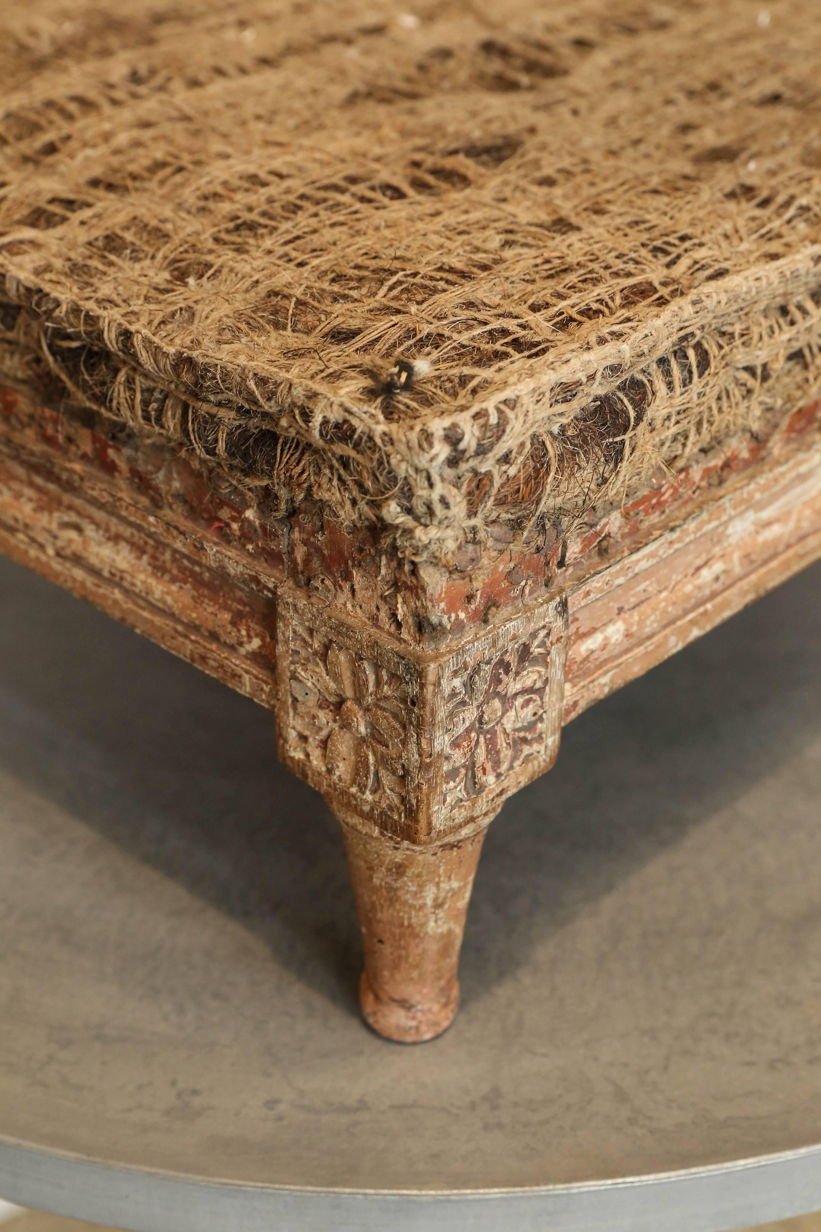 Early carved Louis XVI footstool with traces of original paint.