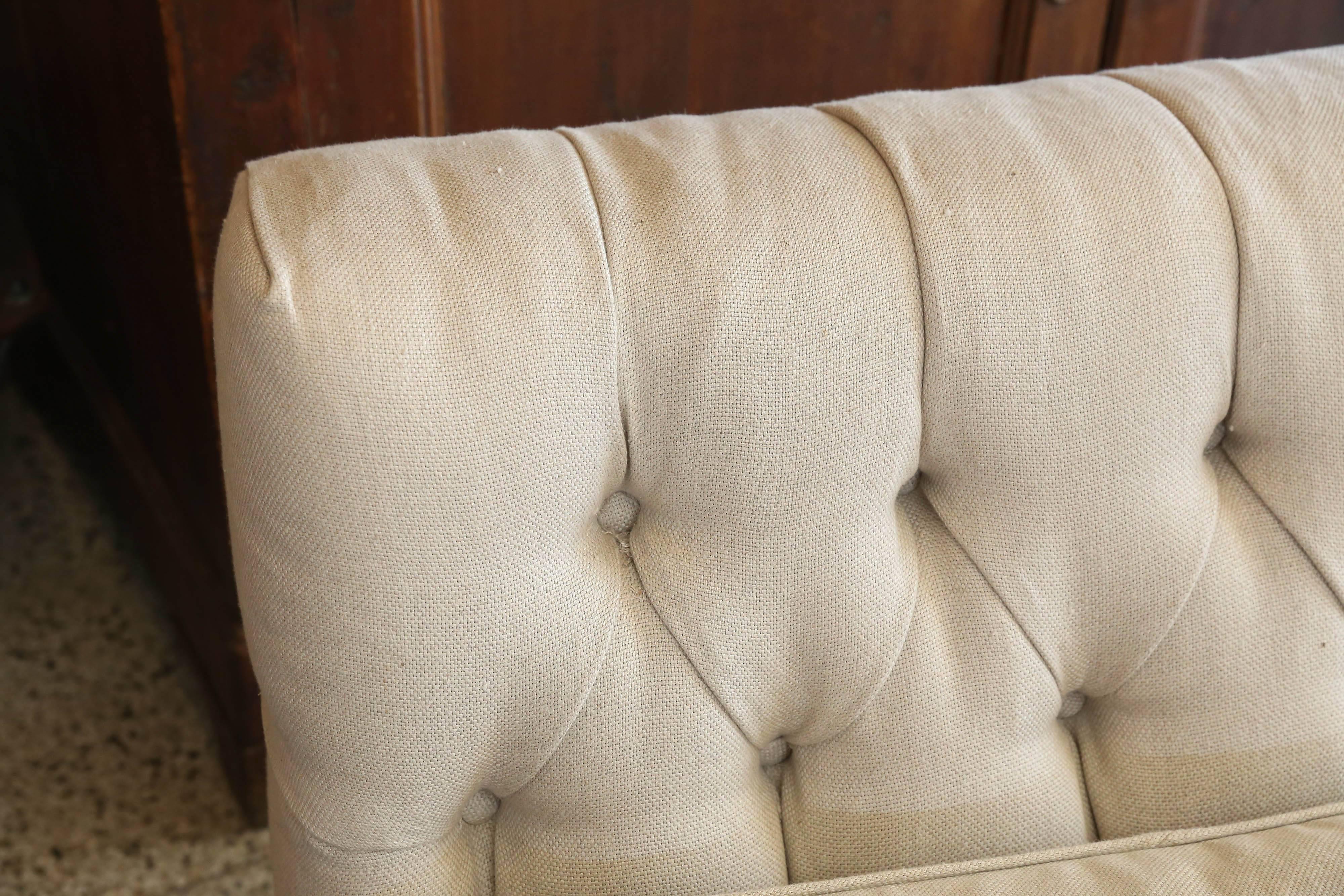 Vintage low armless sofa with down wrapped cushion and tufted back. Reupholstered in Coleman and Taylor linen. Two sofas available at $5800 each. Would make a great pair.
