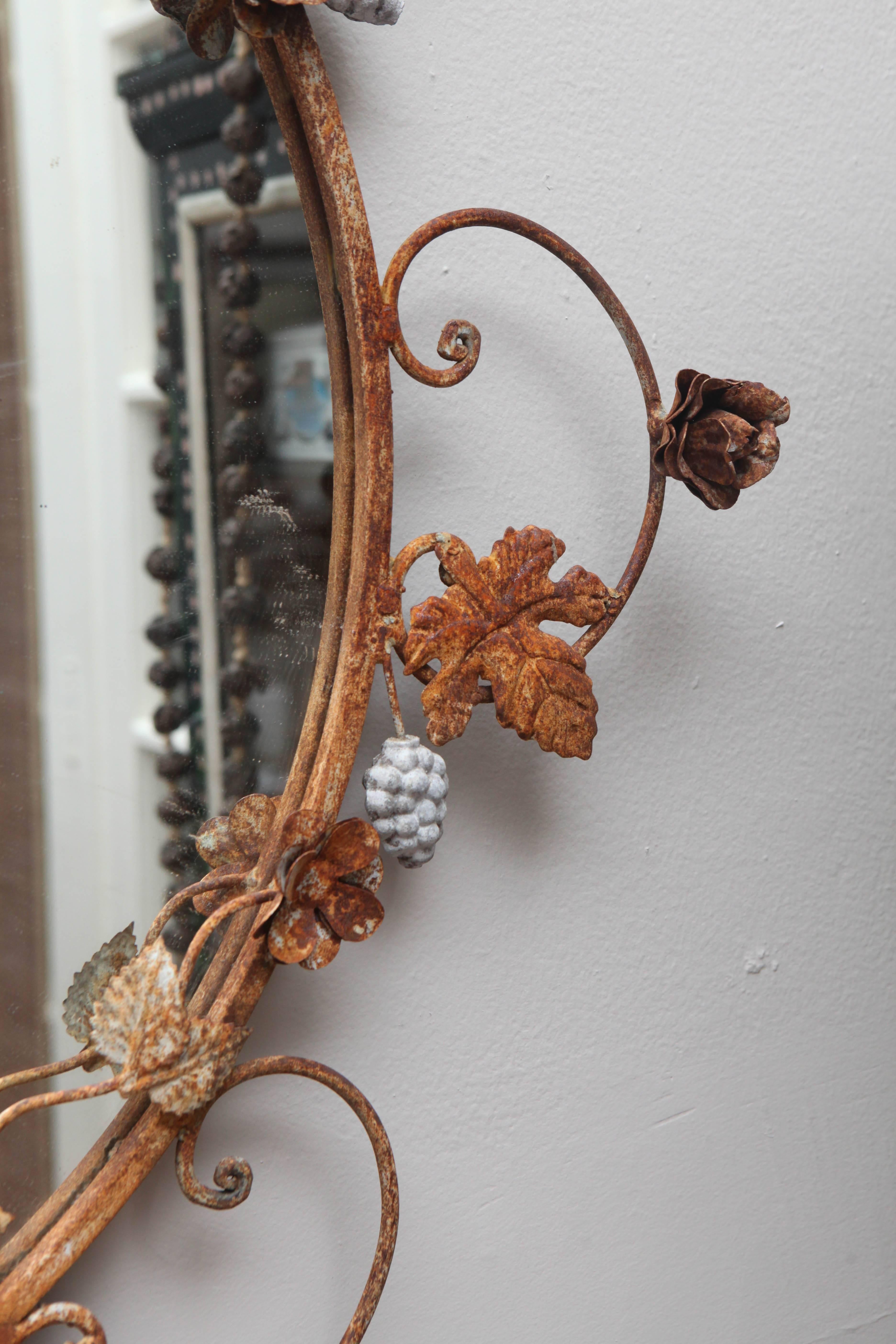 Vintage rusted mirror. Hand wrought iron.  Probably not terribly old but great look.  Round mirror inset is new.  Some remnants of white paint and quite rusted.