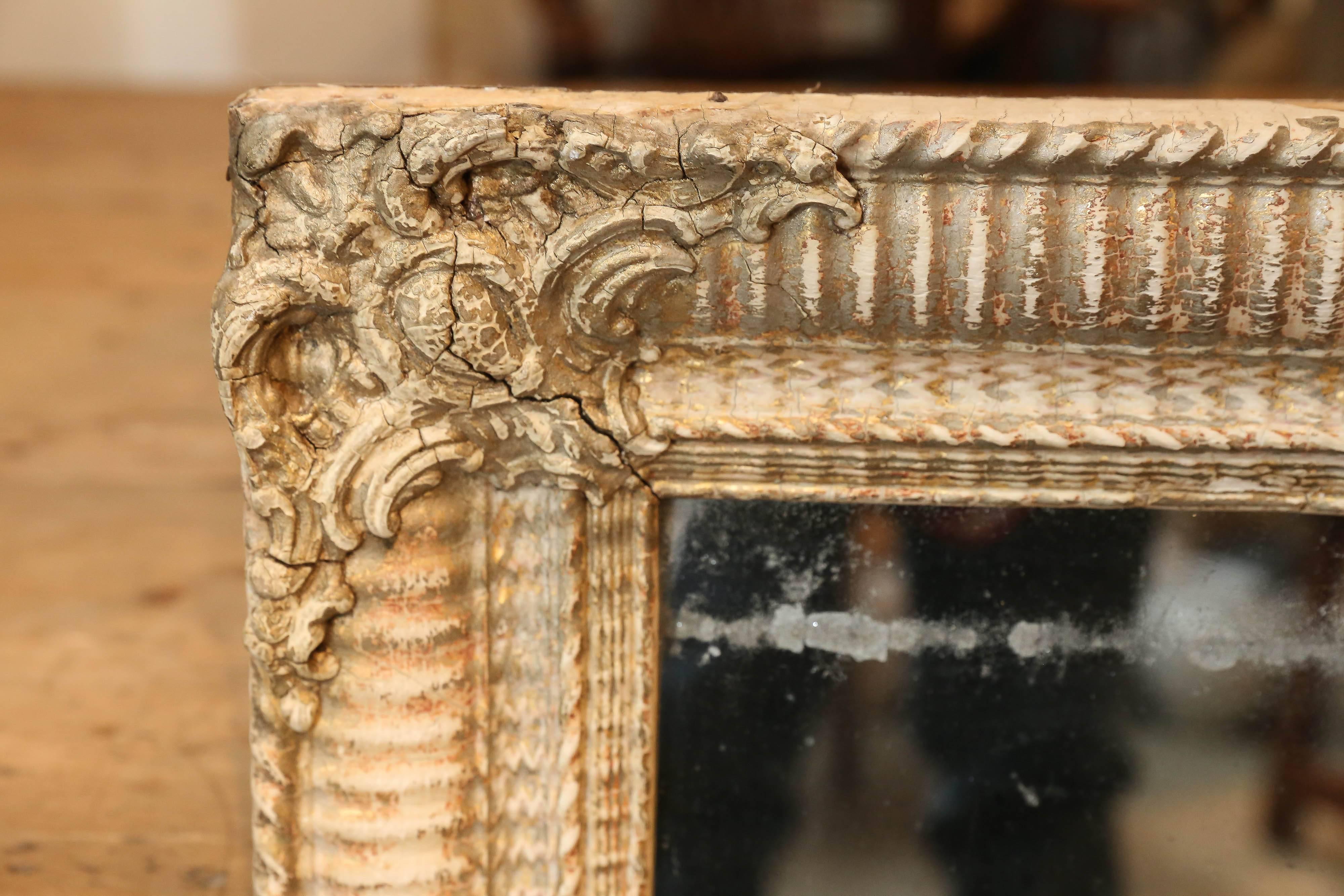 19th century Bois doré mirror with details in corner from France. Mercury glass. Can be hung horizontally or vertically.