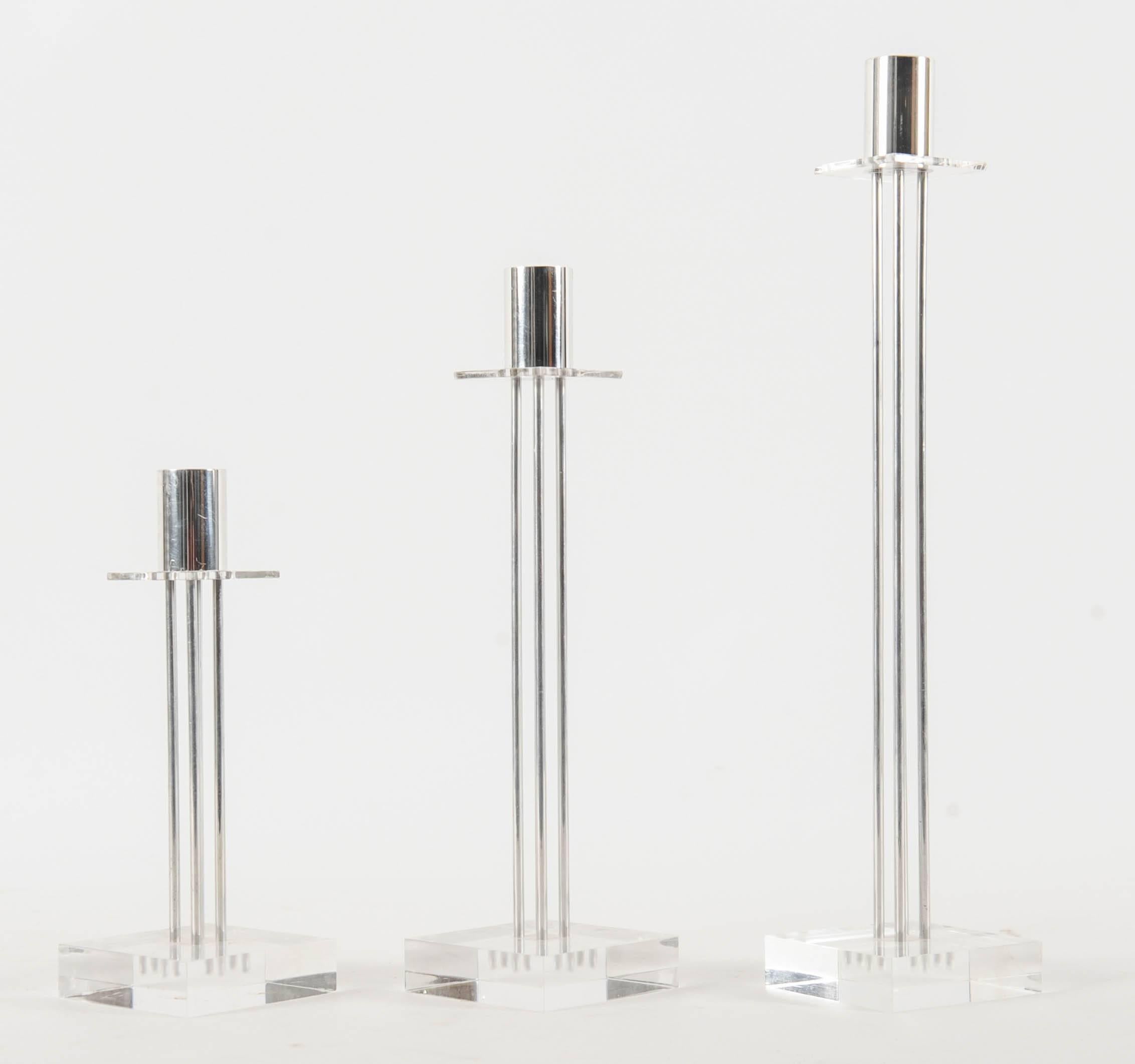 Set of three candle holders designed and made by Studio Van Eldik in Follega. They are made of stainless steel, sitting on plexiglass. 

Three different heights: 33.5, 26.5 and 19 cm.