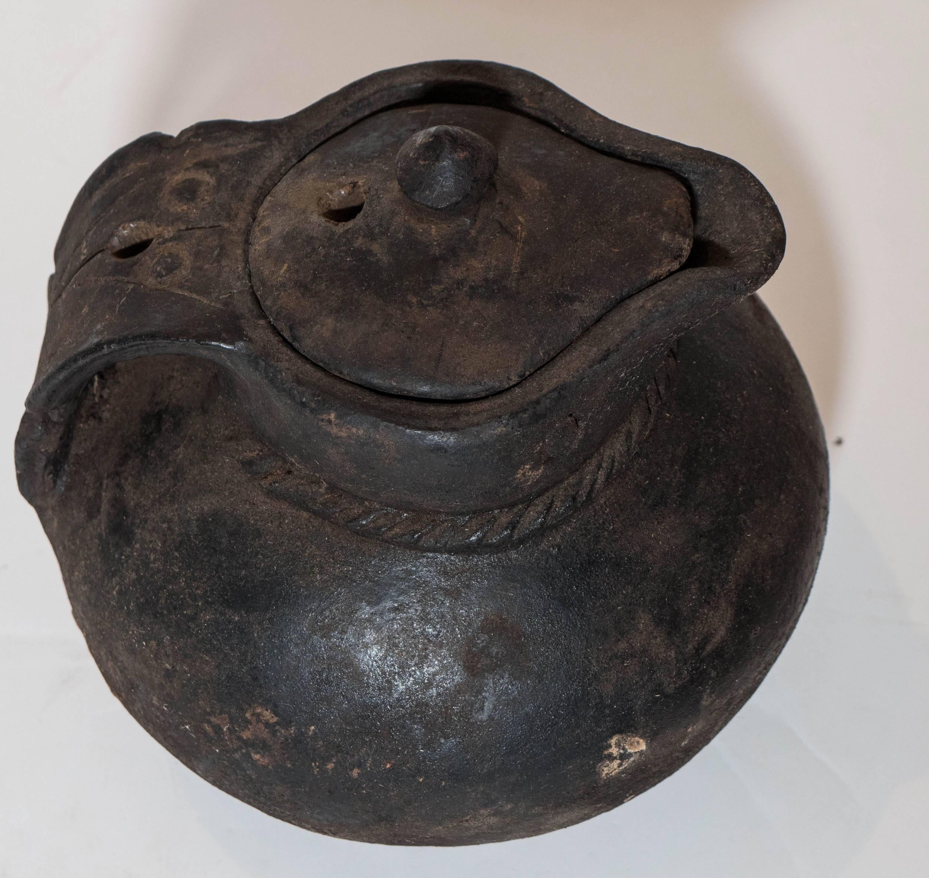 A simple clay covered pitcher from Tibet, circa 1920.  
CR384.