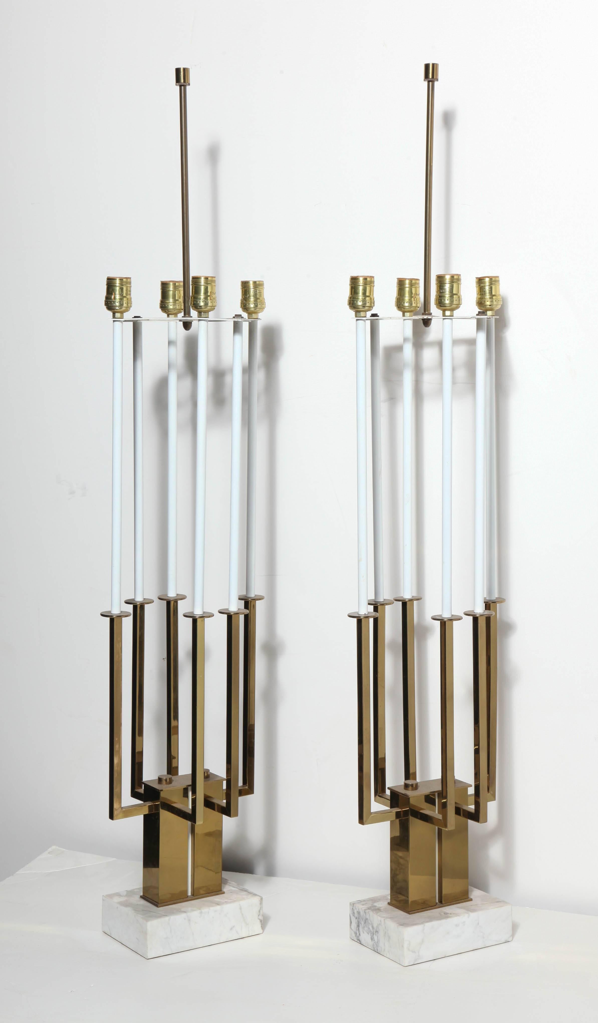 Substantial pair of Stiffel Lamp Company White, Brass and White Marble Candlestick Table Lamps in the style of Tommi Parzinger.  Featuring a six candlestick White enameled sleeve and plated Brass framework on a rectangular (2D x 7L) White Carrara