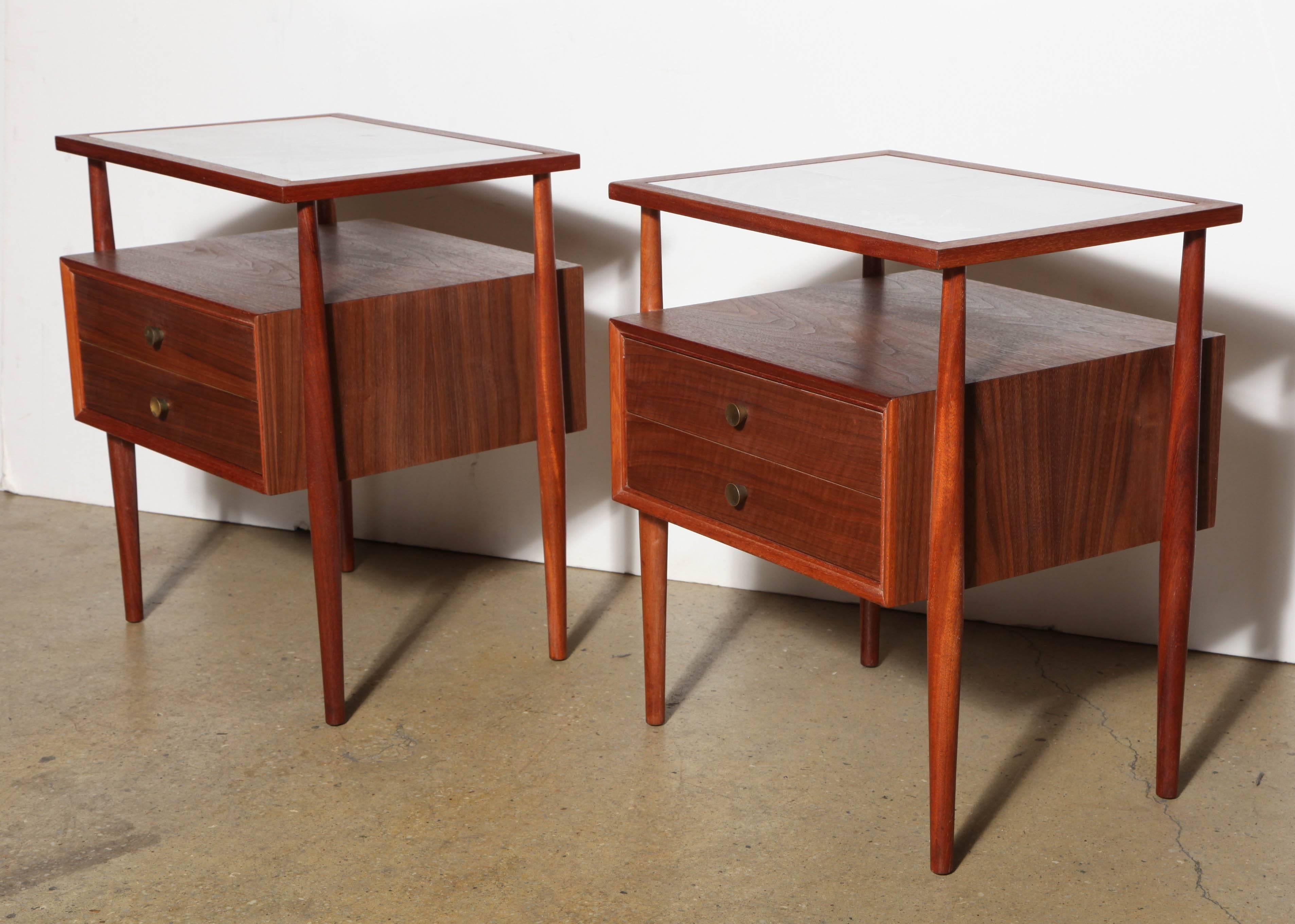 pair of Landstrom Furniture of Rockford, Illinois Bedside Tables.  Featuring rectangular form in Mahogany, Walnut and White Glass with two drawers.  
Each Table hung from 4 Mahogany dowel legs with matched Walnut drawers, containing addtional