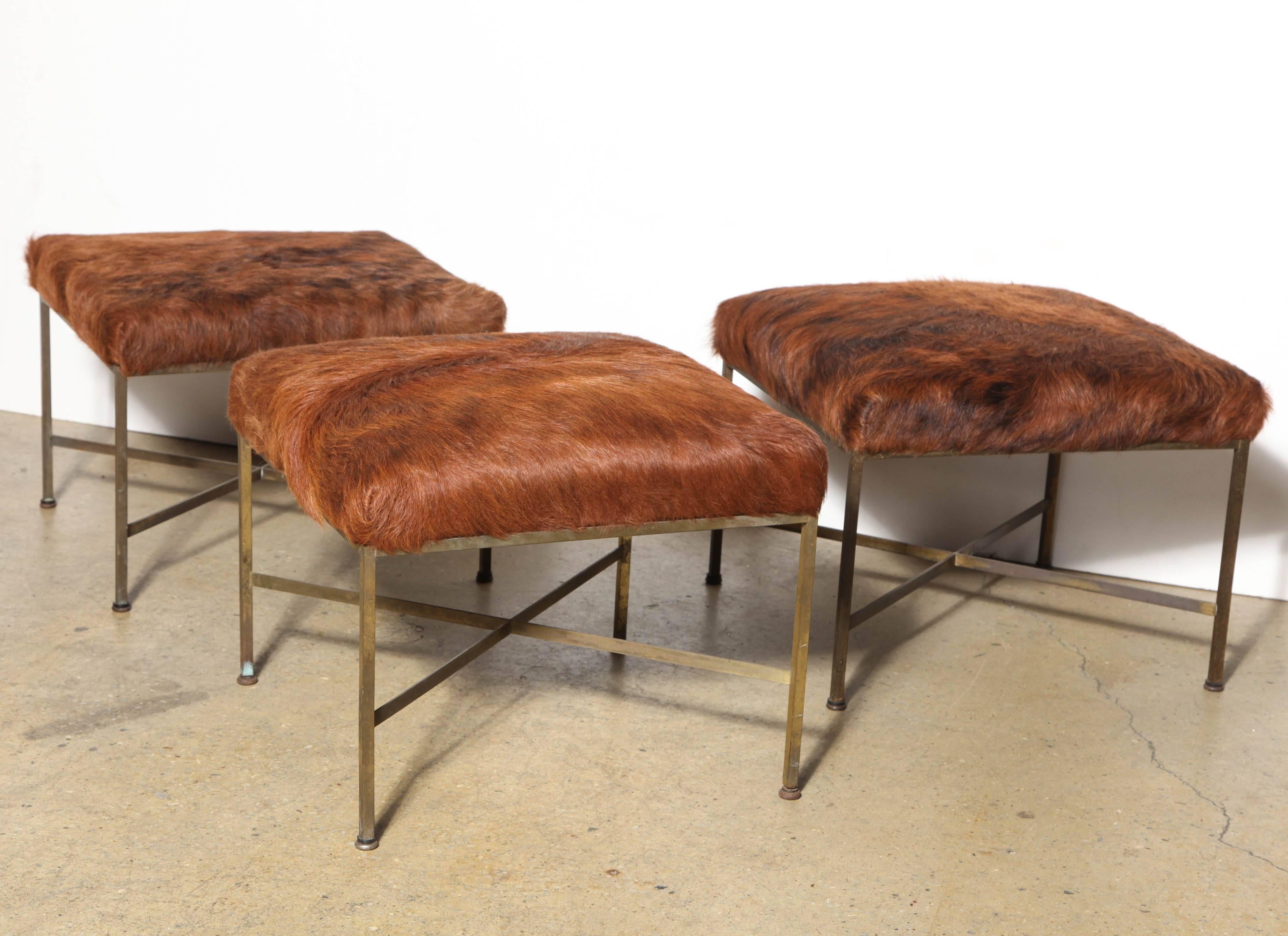 Set of 3 Paul McCobb for Directional Brass Cross Frame Occasional Stools, 1956 designed. Featuring classic Brass square seat, X base and tubular legs. Original condition with old Bronze patina. Upholstered in Cowhide. Western. Versatile. Repurpose.