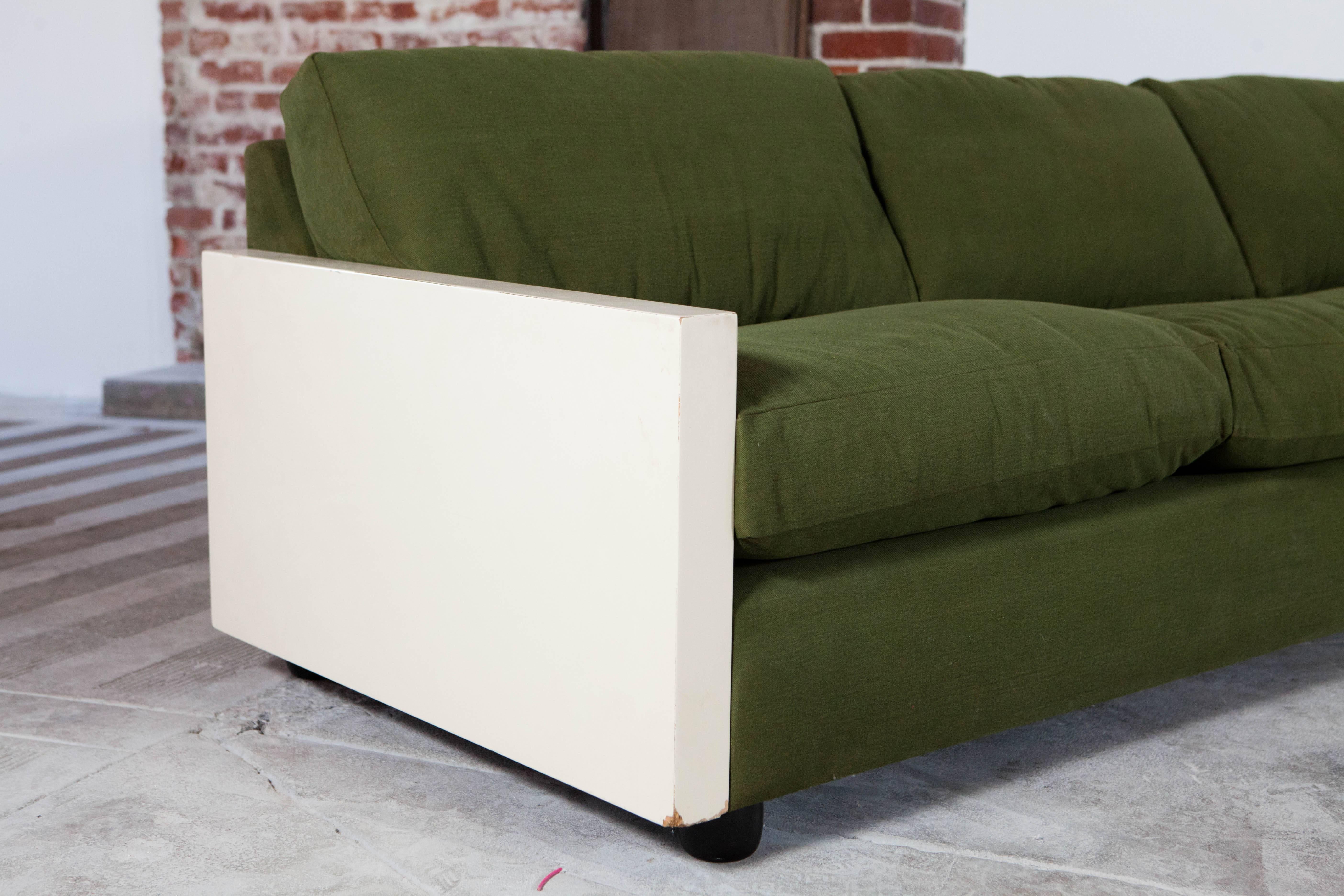 Handsome midcentury ivory painted arm sectional upholstered in olive green canvas. 

Left arm measures: 85