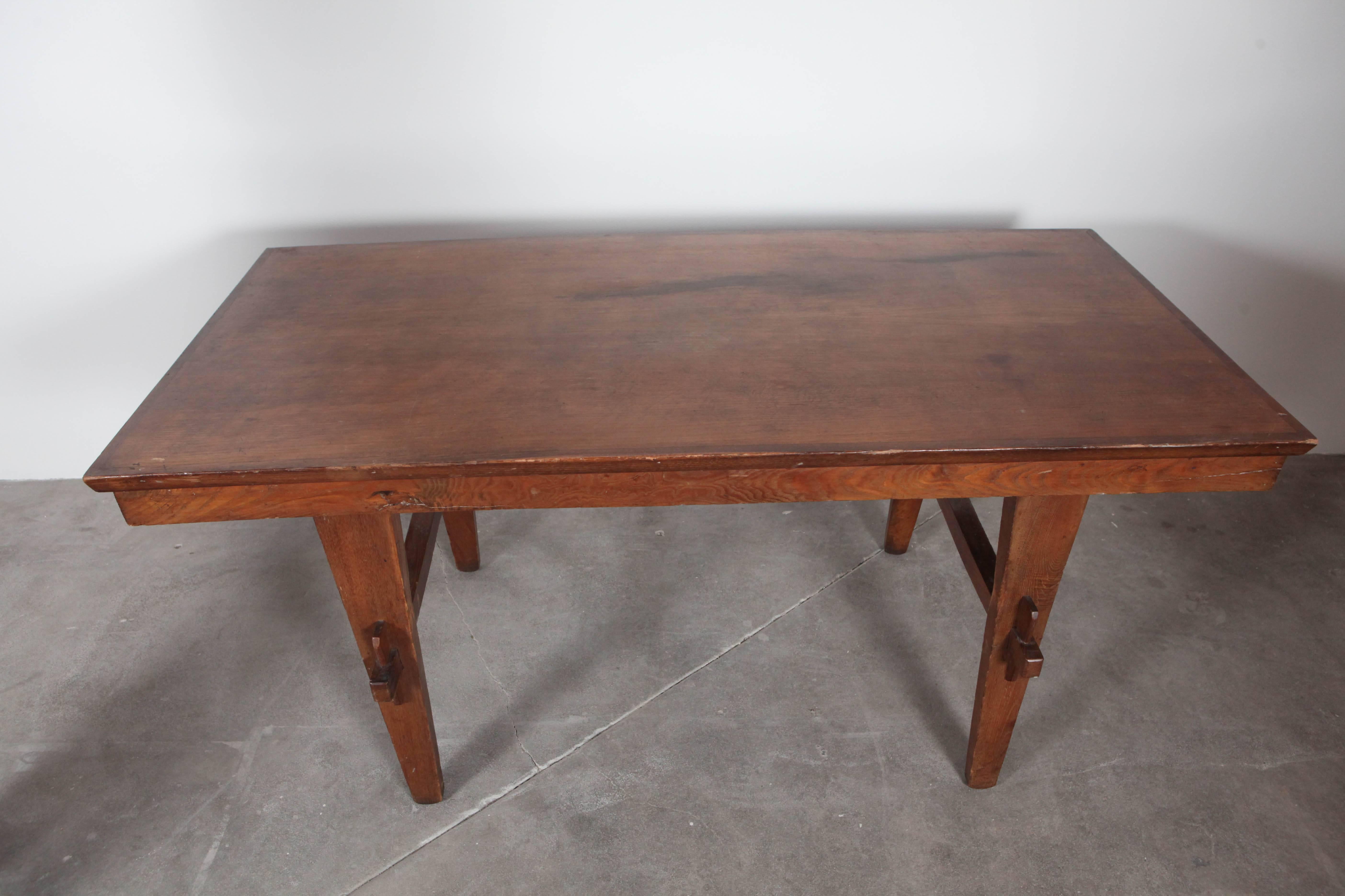 Vintage dining table with peg and groove leg supports.