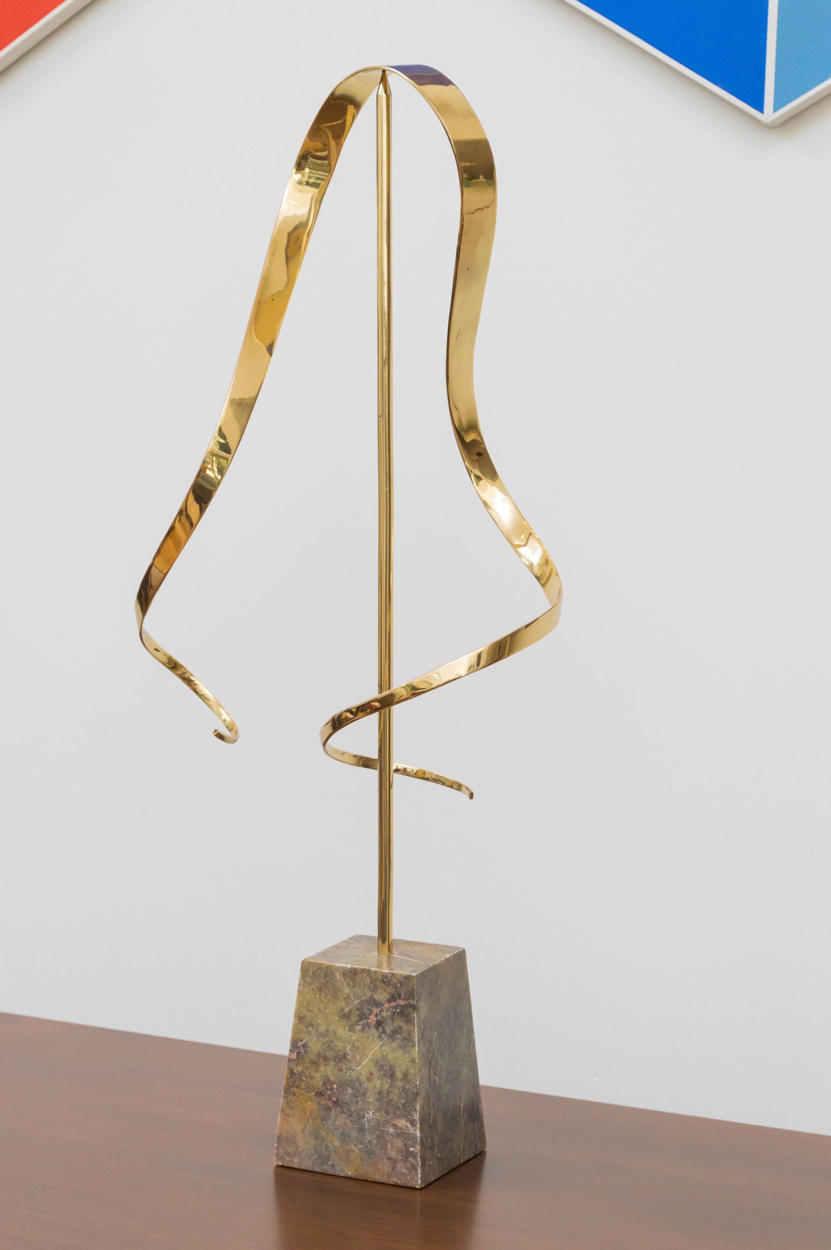 Polished brass kinetic sculpture with a marble base. Unsigned.