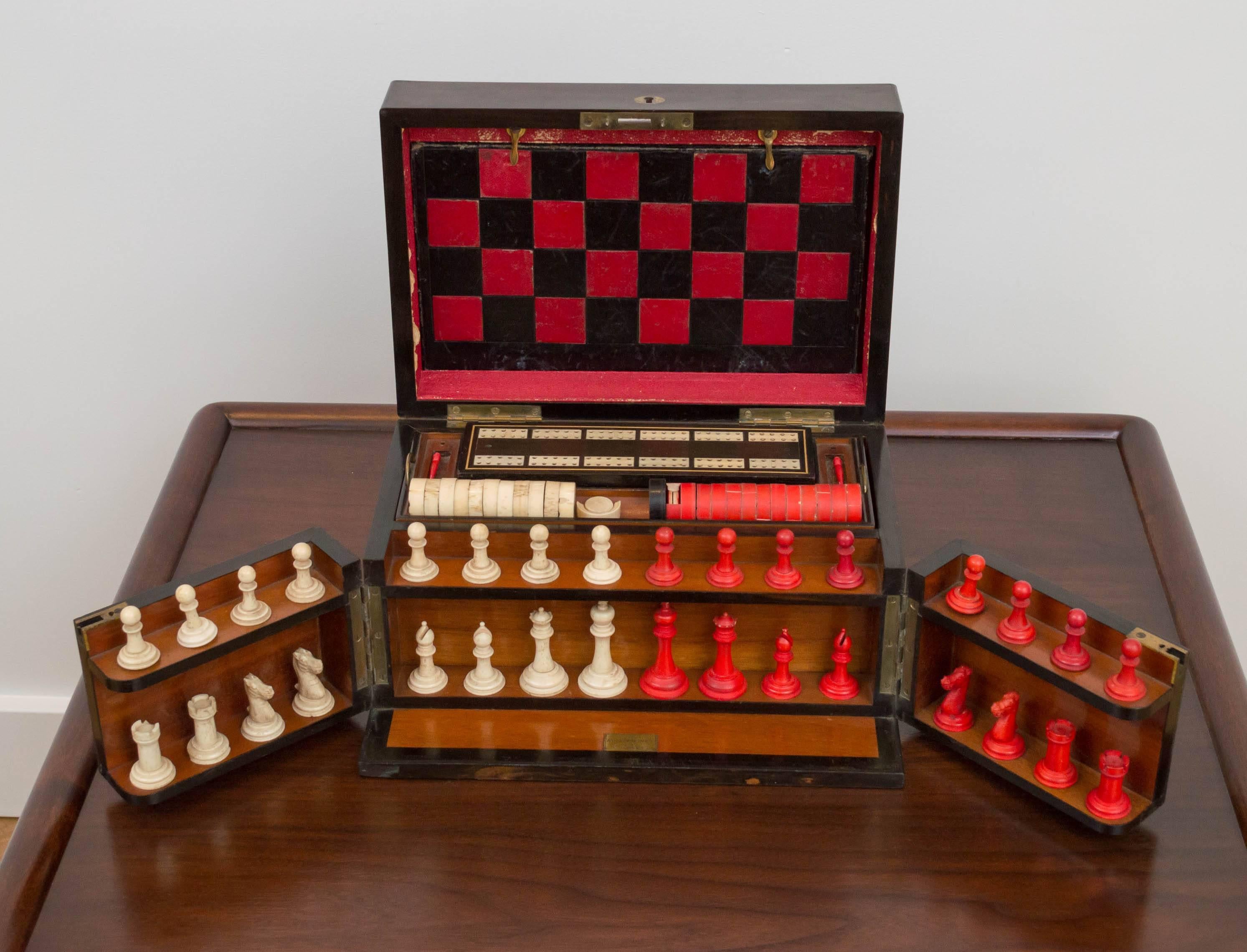 Amazing English game chest from the 1800s, has hand-carved bone chess and checker pieces, leather embossed game board inlaid cribbage board.
Everything in the game chest is beautifully handcrafted. A few of the bone checker pieces are a bit damaged