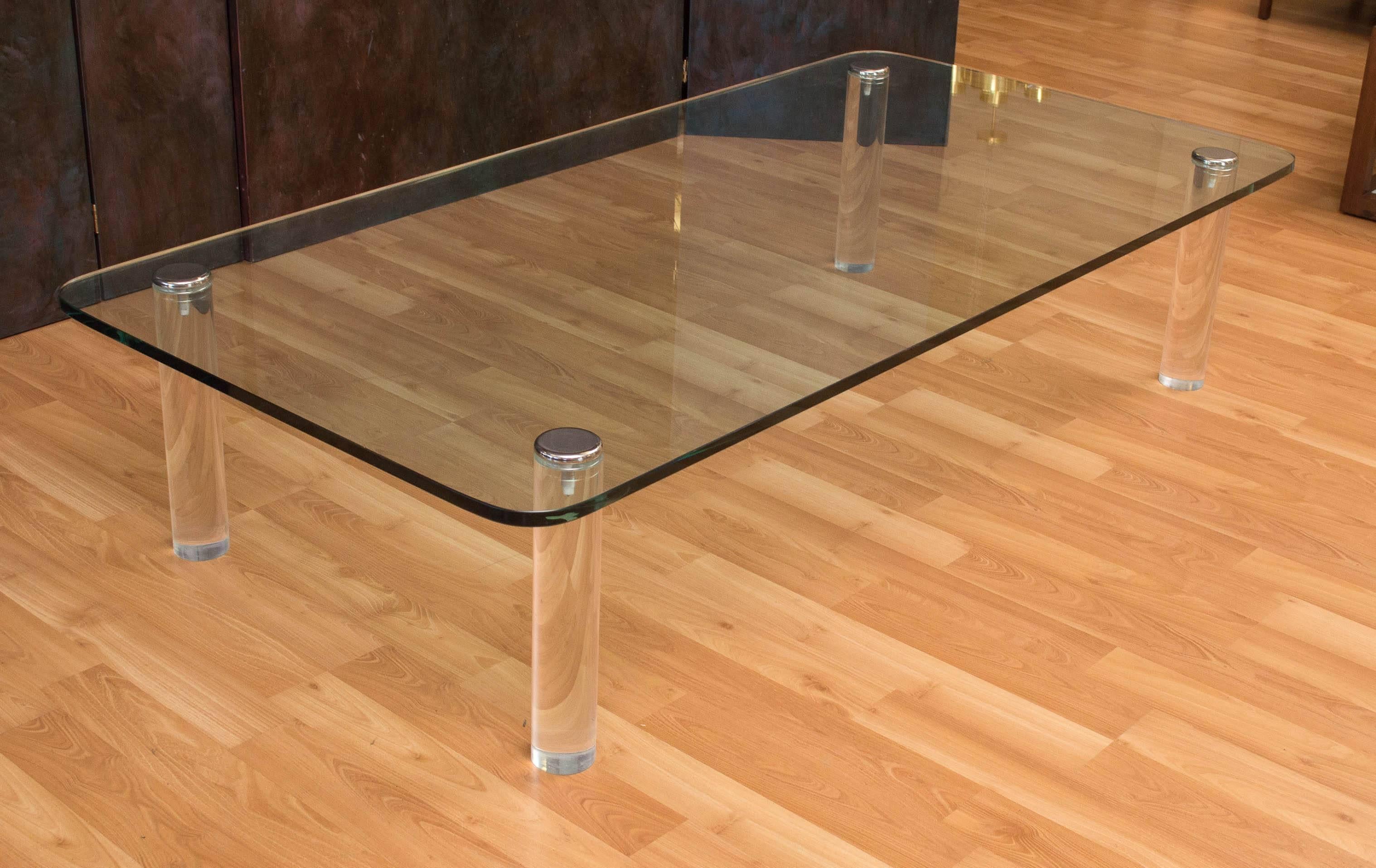 A very large glass coffee table with Lucite legs and chrome caps, Leon Rosen for Pace Collection