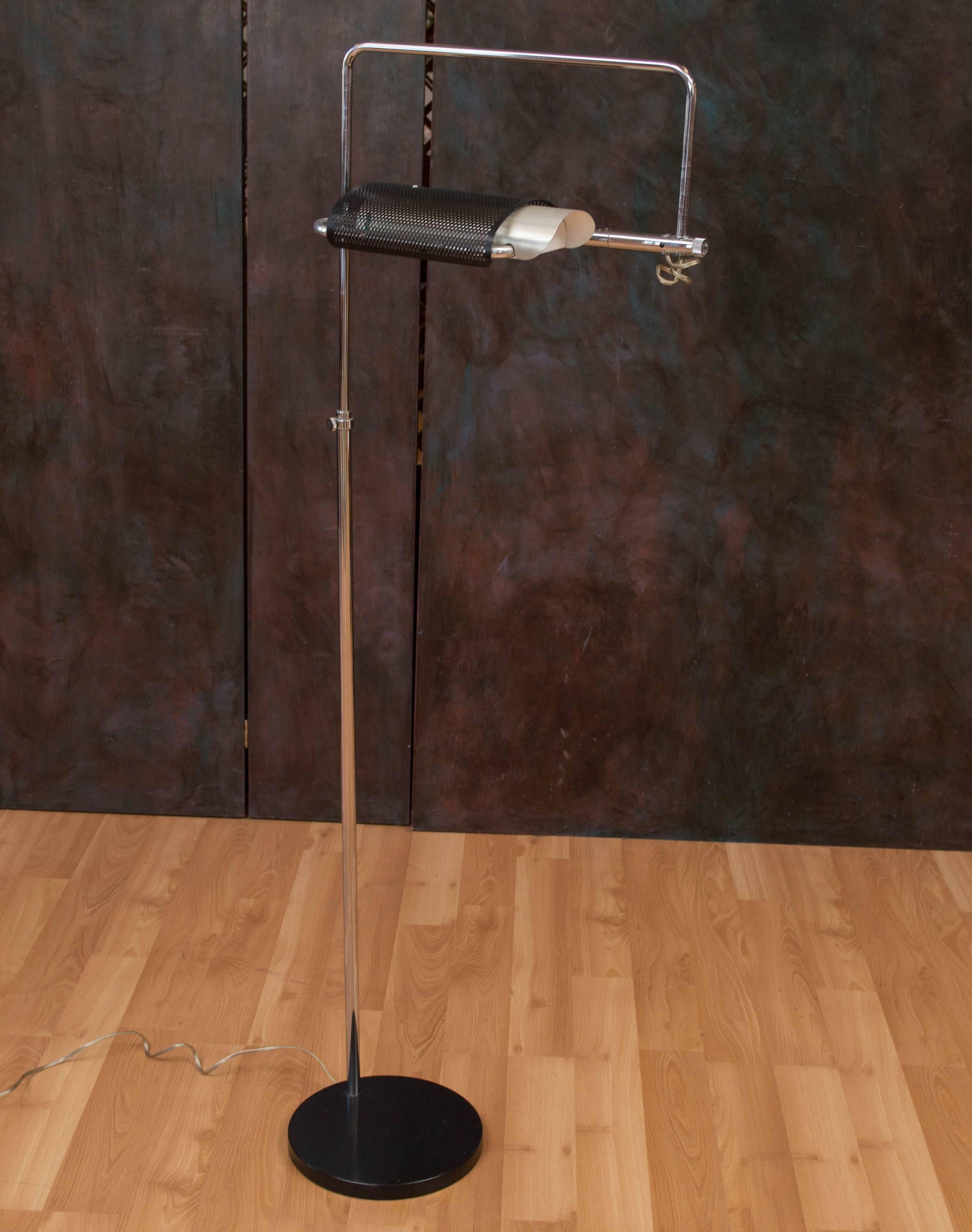 Eyeshade Series Floor Lamp with a black perforated enameled aluminum shade, has the green translucent end panel. Iron base with black steel plate over, and chrome stem to shade/main part. Lamp is fully adjustable up/down, right/left, as with the