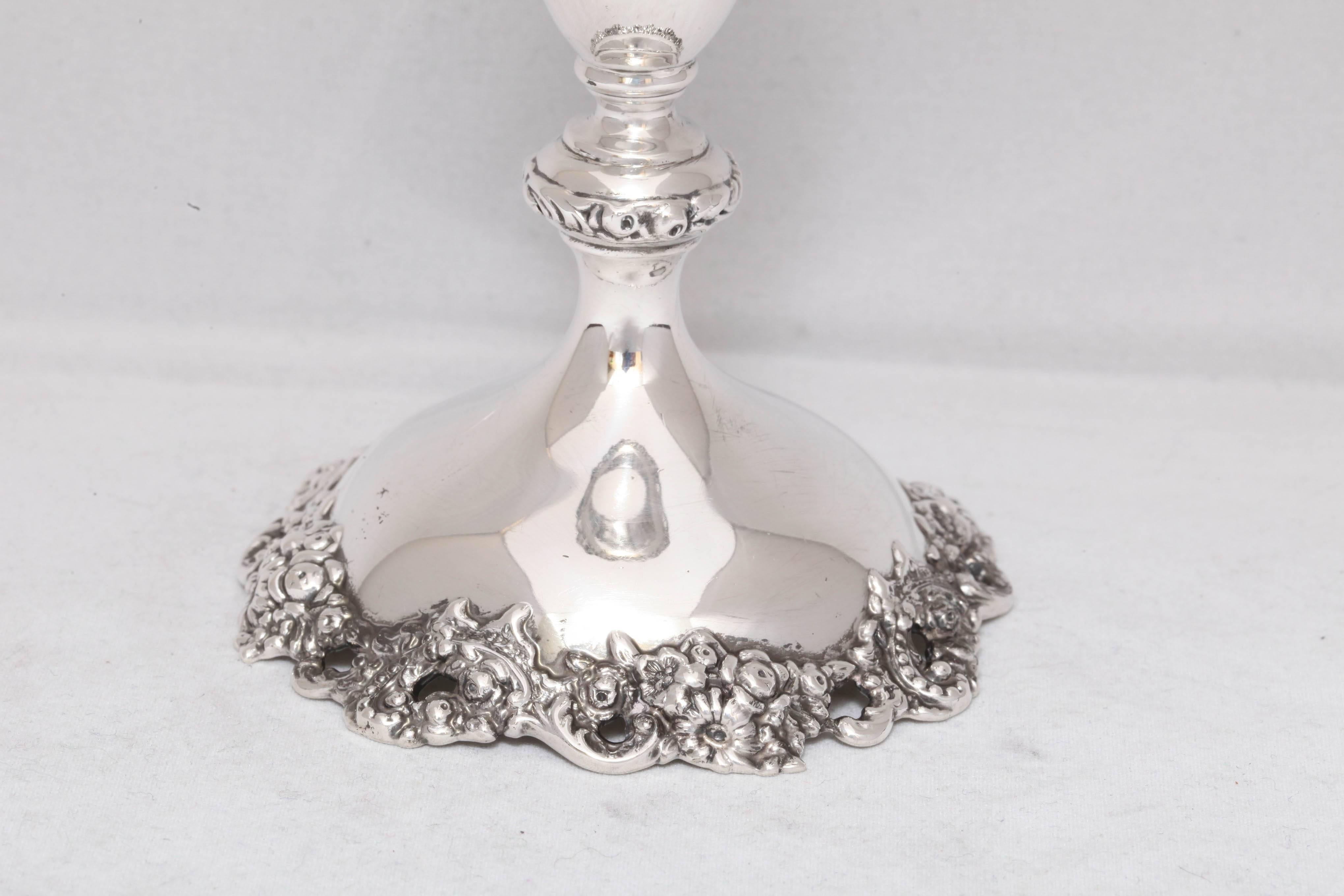 Art Nouveau, sterling silver vase, Theodore B. Starr, New York, circa 1900. Measures: 8 inches high x 3 1/4 inches diameter across opening. Pierced floral motif around opening; motif is picked up on edge of baluster base. Unweighted: weighs 5.105