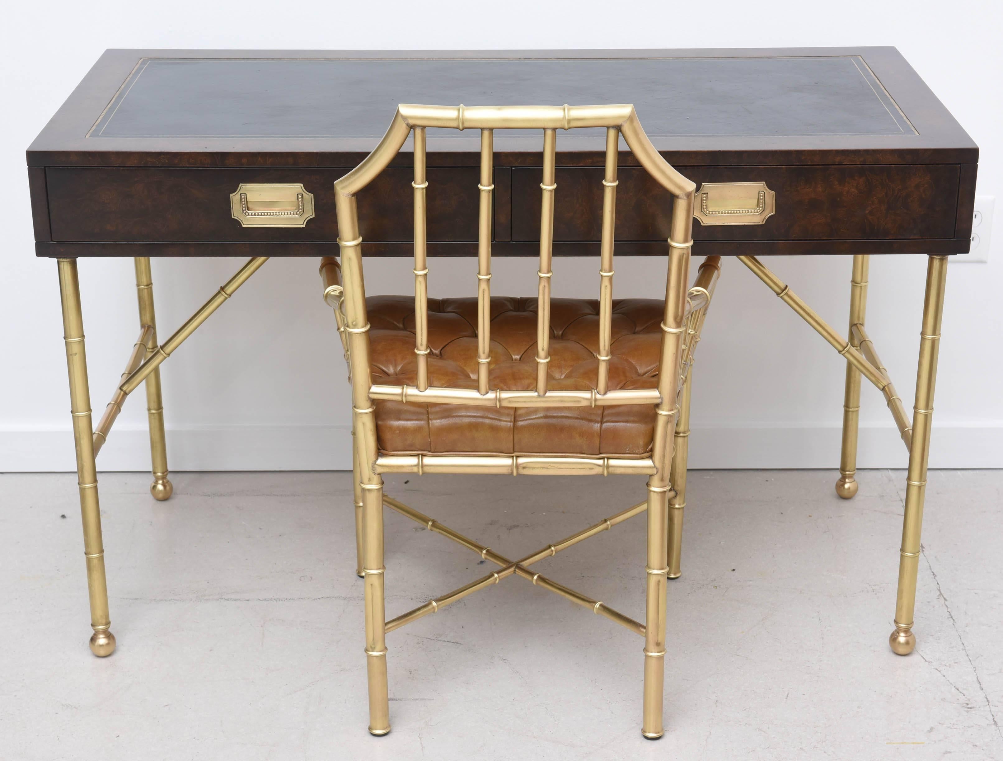 Vintage Mastercraft desk with brass base. The base has a bamboo motif and the top is leather. The coordinating chair is Chippendale style, also with faux bamboo motif. 
Desk measures:
30