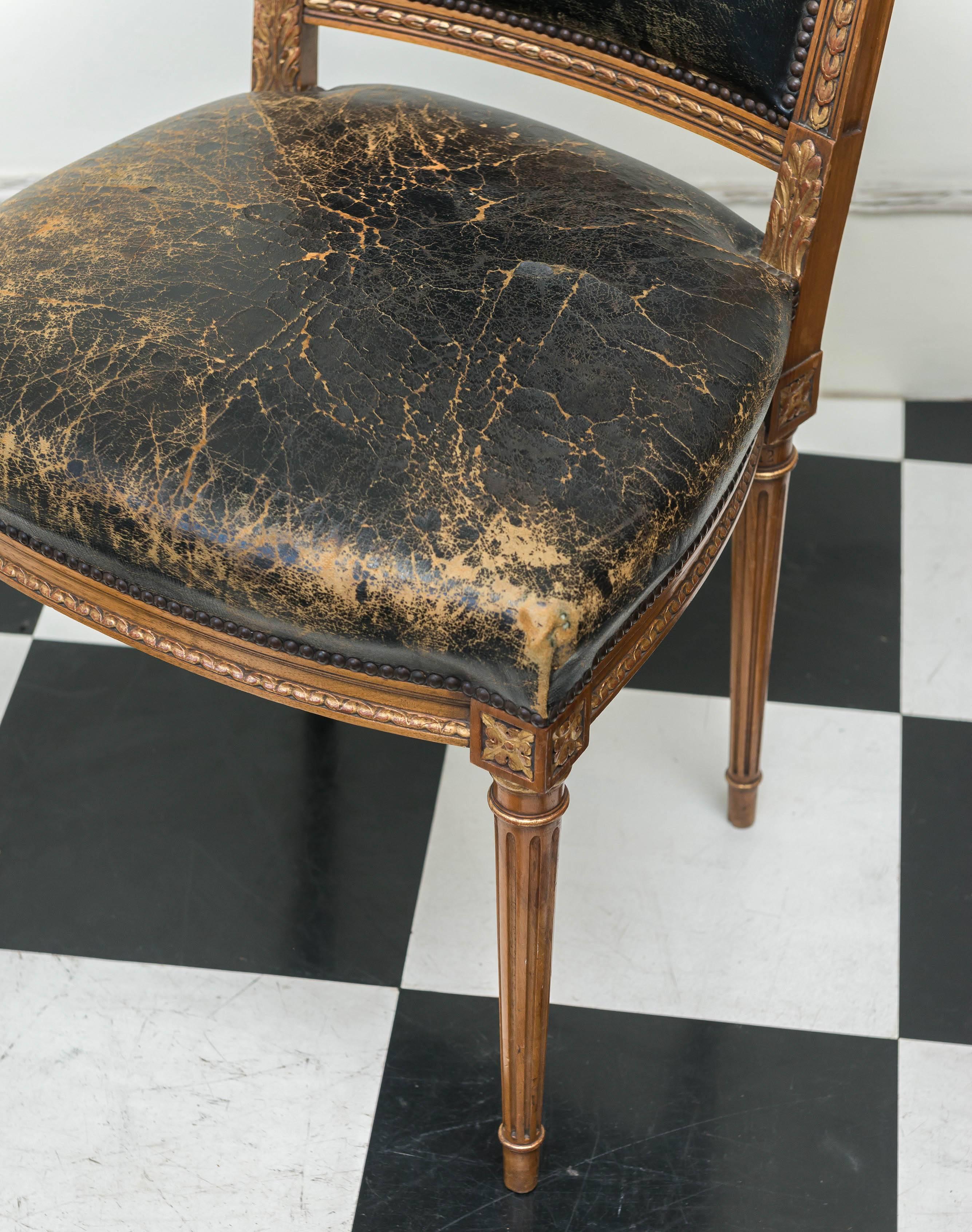 Louis XVI Revival Style chair by Simon Loscertales Bona, Zaragosa, Spain. Carved walnut details with gilt decoration and black leather with tack detail. Original label affixed to bottom 