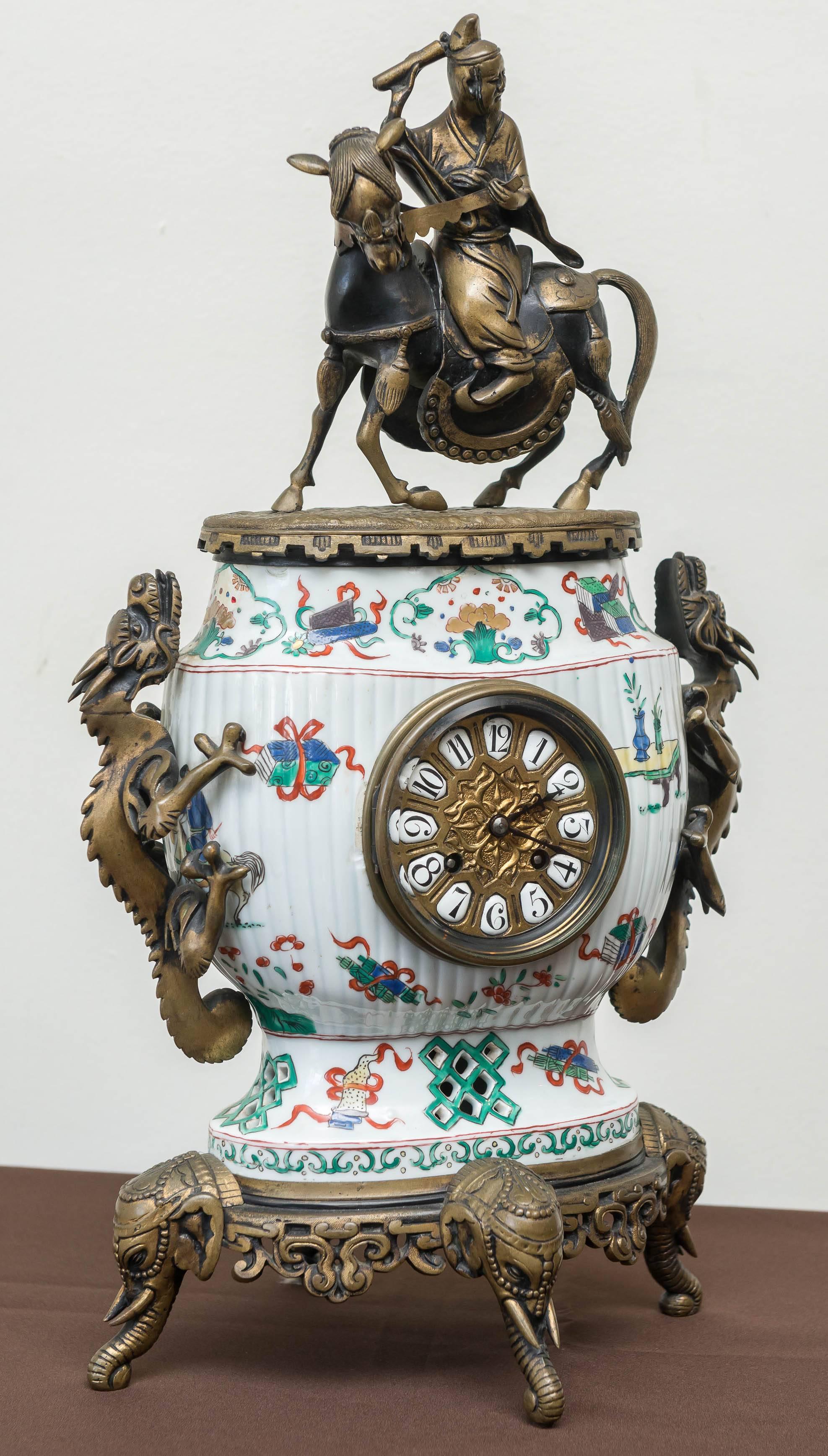 19th century, French clock In the Chinoiserie style. An 8 day pendulum movement that bell strikes on the hour and half hour. Chinese porcelain body in the Kang His style by Samson. The Samson factory was an exemplary porcelain manufacturer of Asian