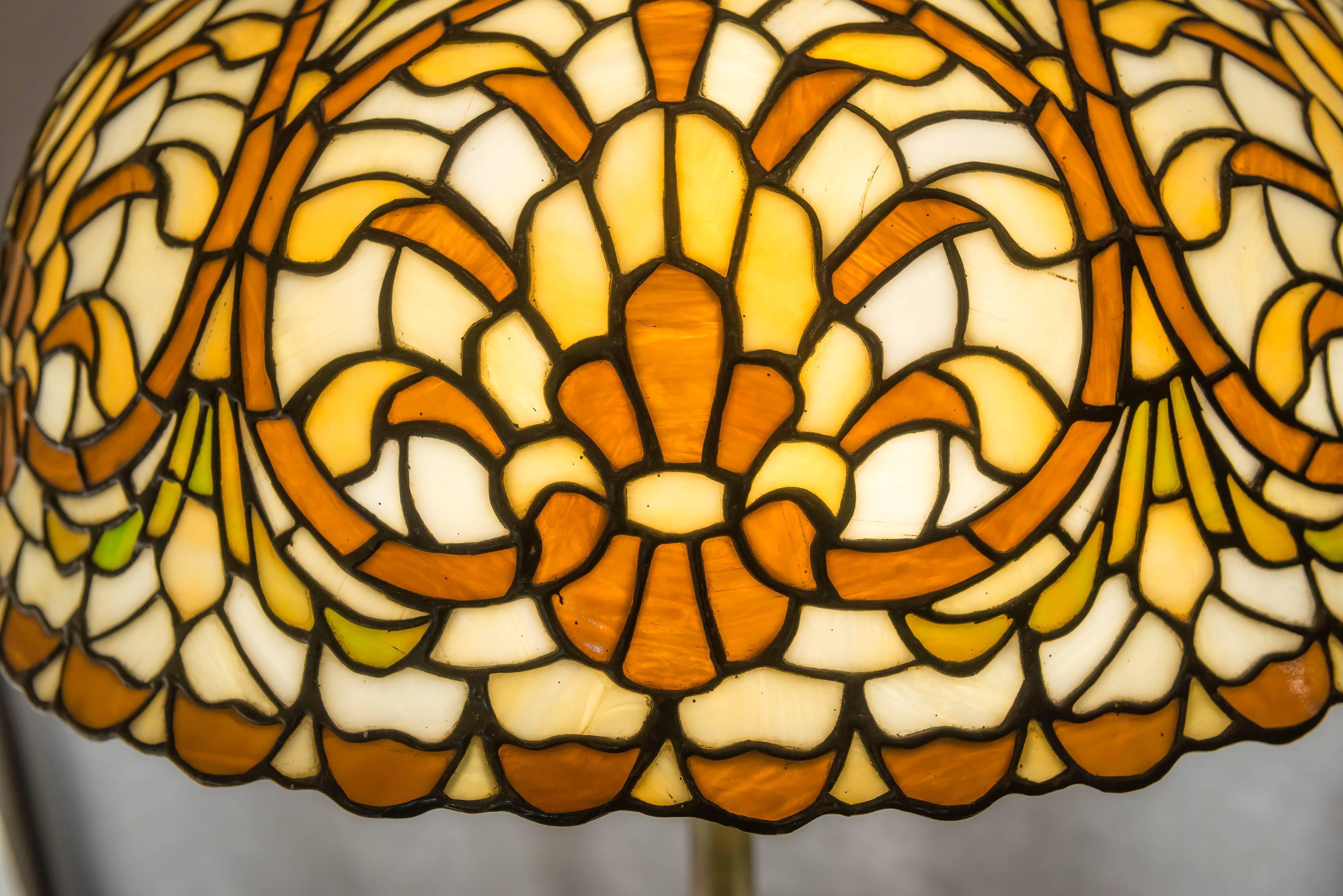   This is a fine example of a complicated geometric leaded glass table lamp. We know it was done by Lamb Bros. Napanee Indiana, and done between 1910 and 1920. We know our lamps even when they are unsigned. This has a beautiful design, and some