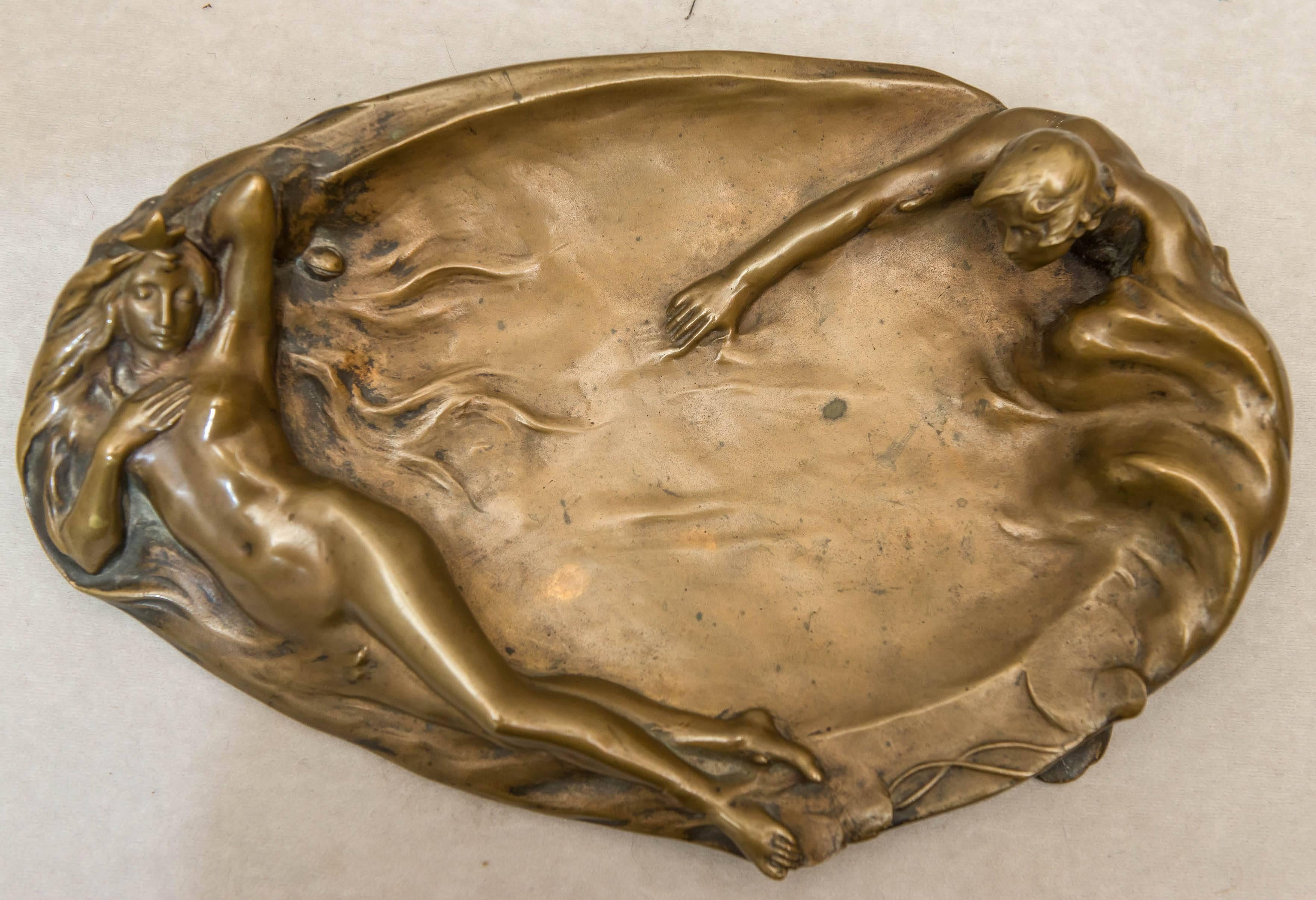 This alluring and sexy tray, also known as a vide poche is artist signed S. Richter. Richter was Austrian and produced many fine bronze sculptures. The poor fellow is desperately trying to swim towards the nude maiden. A beautiful, whimsical and