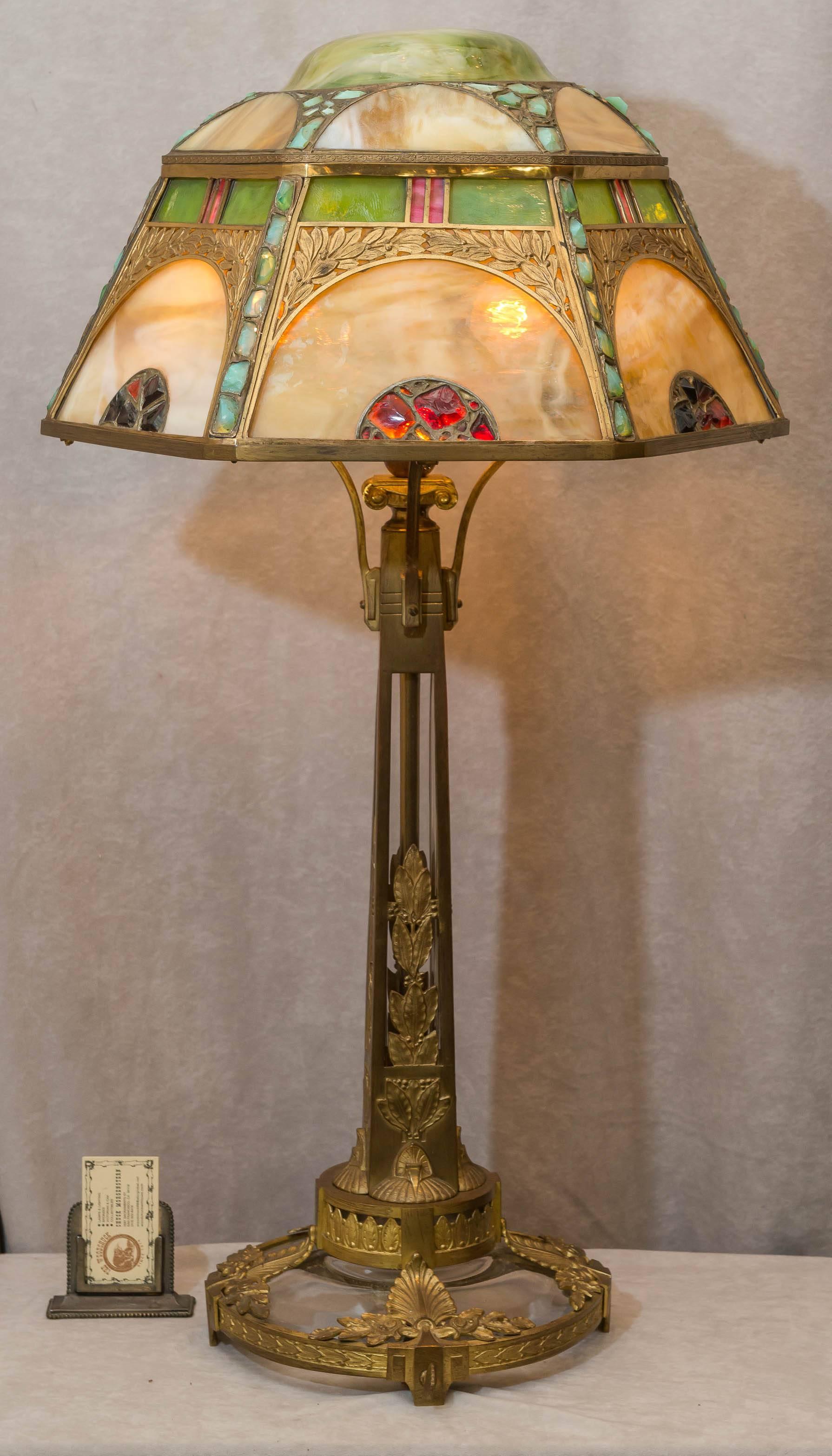 We have been buying Austrian lighting for decades. We have never seen anything quite like this impressive and exotic table lamp. Rich original gilt finish, colorful jewels and slag glass are just some of the characteristics of this table lamp. While