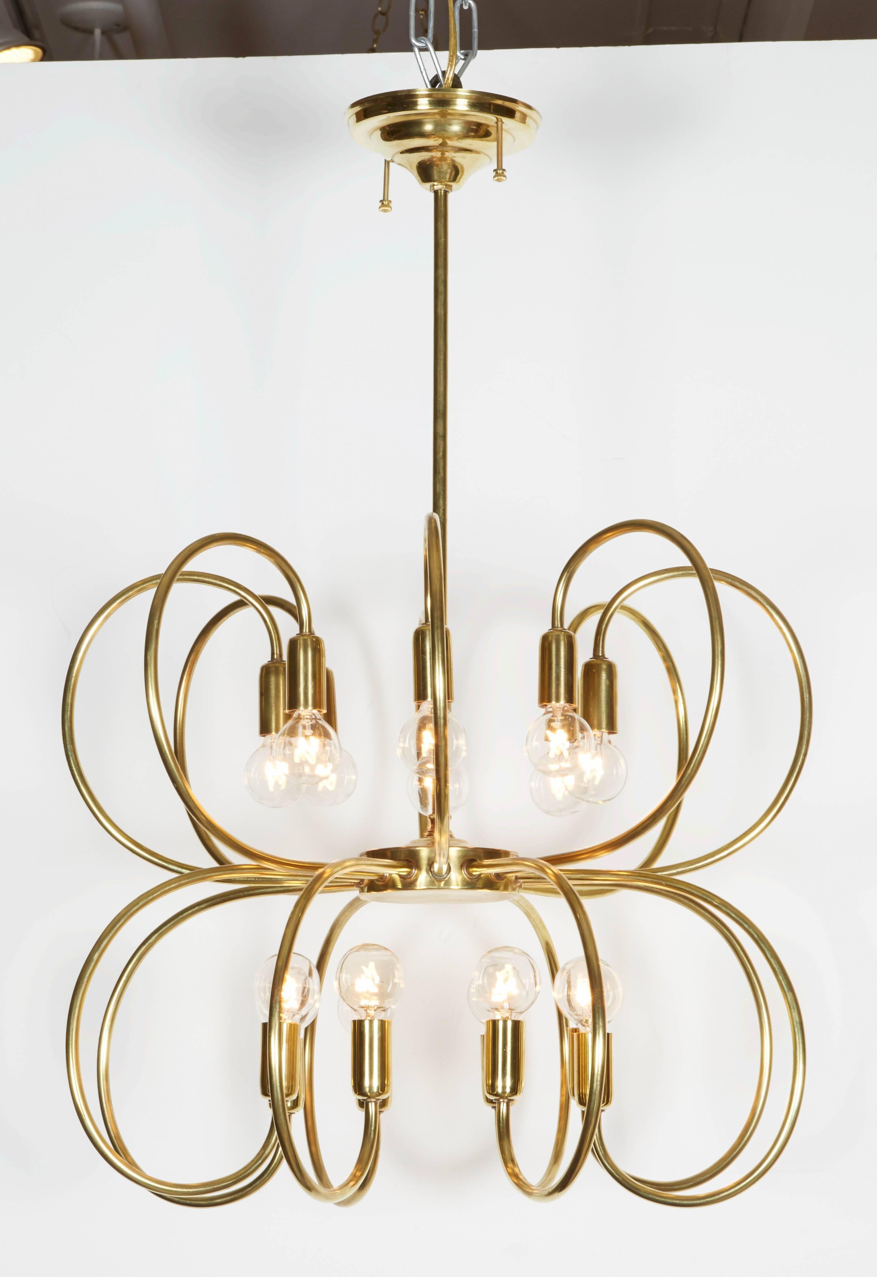 Gorgeous brass pendant chandelier comprised of two tiers of curved, brass arms. A fantastic statement piece in a versatile scale. Please contact for location. Offered by Las Venus by Kenneth Clark, New York City.
     