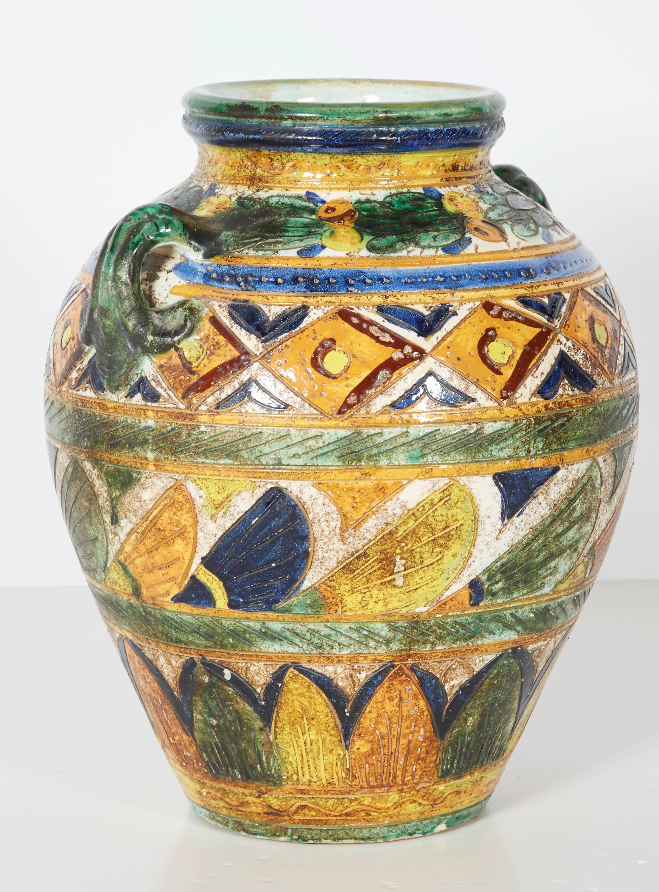 Wonderful large vase done in an etruscan motif. This eye catching piece is executed in a colorful, earthy, textured finish. Please contact for location. 