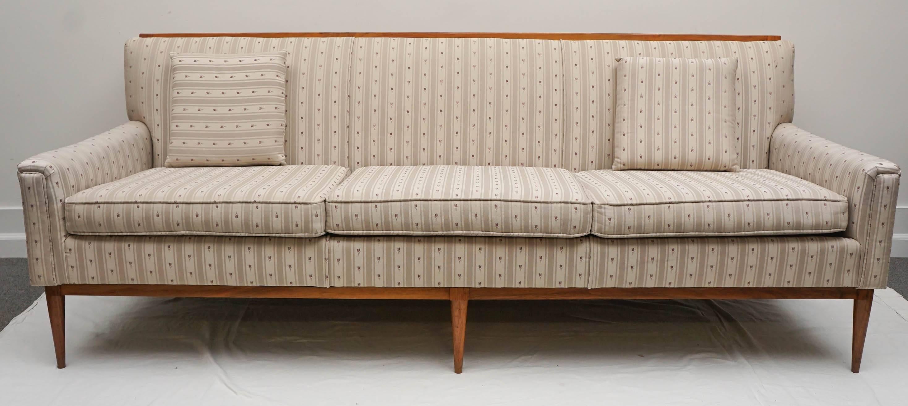 this sofa is really fantastic. it was most likely redone in the 90's I would guess.
its pretty much pristine, however the fabric is quite dated.
the frame is sturdy and looks great. This style from McCobb is his most desirable today. 