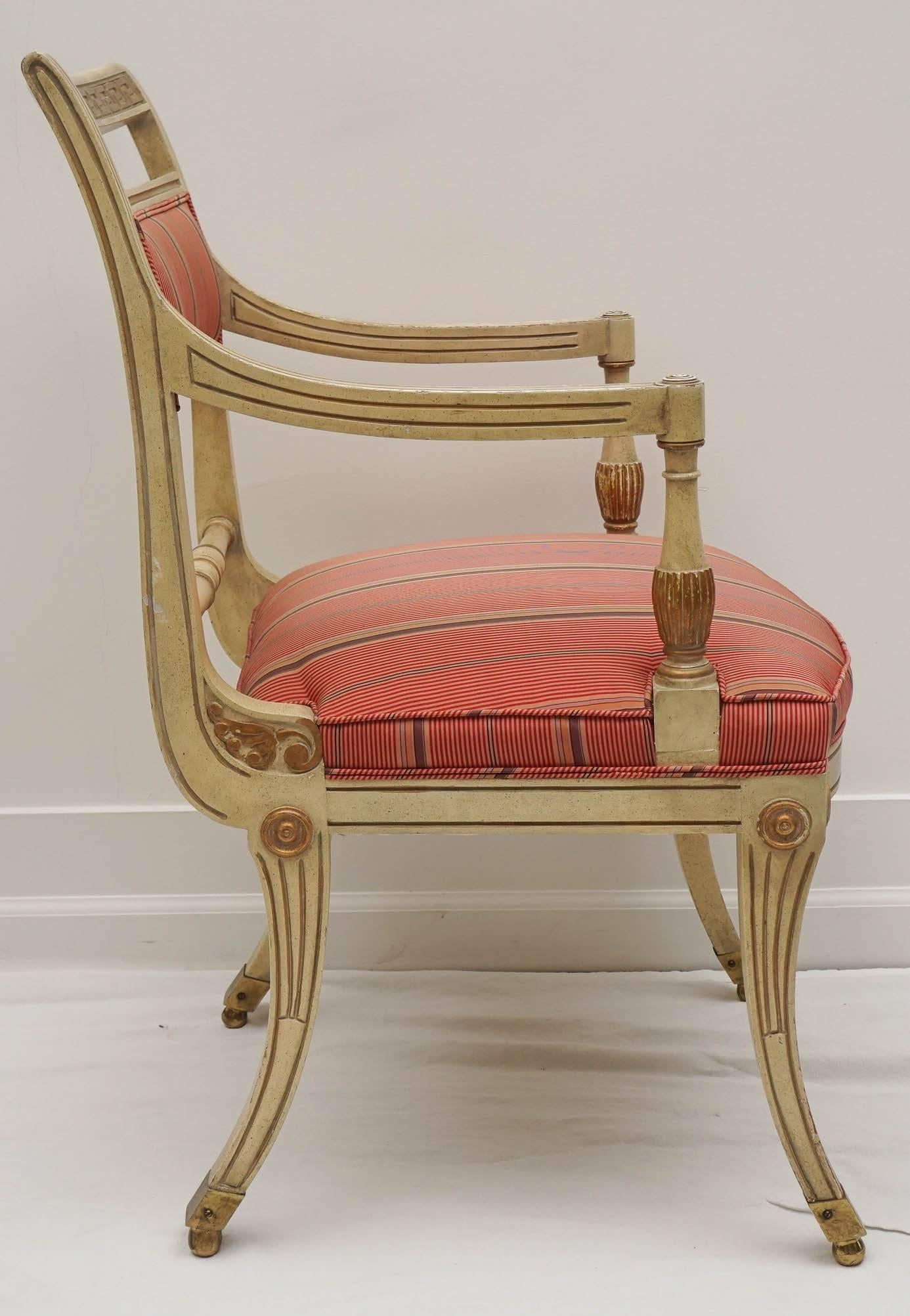 this chair has it all from the Hollywood Regency period.
the klismos legs, the Greek Key trim, the gold leafing, and the brass feet!
the fabric is very usable. however, and update would be best.   