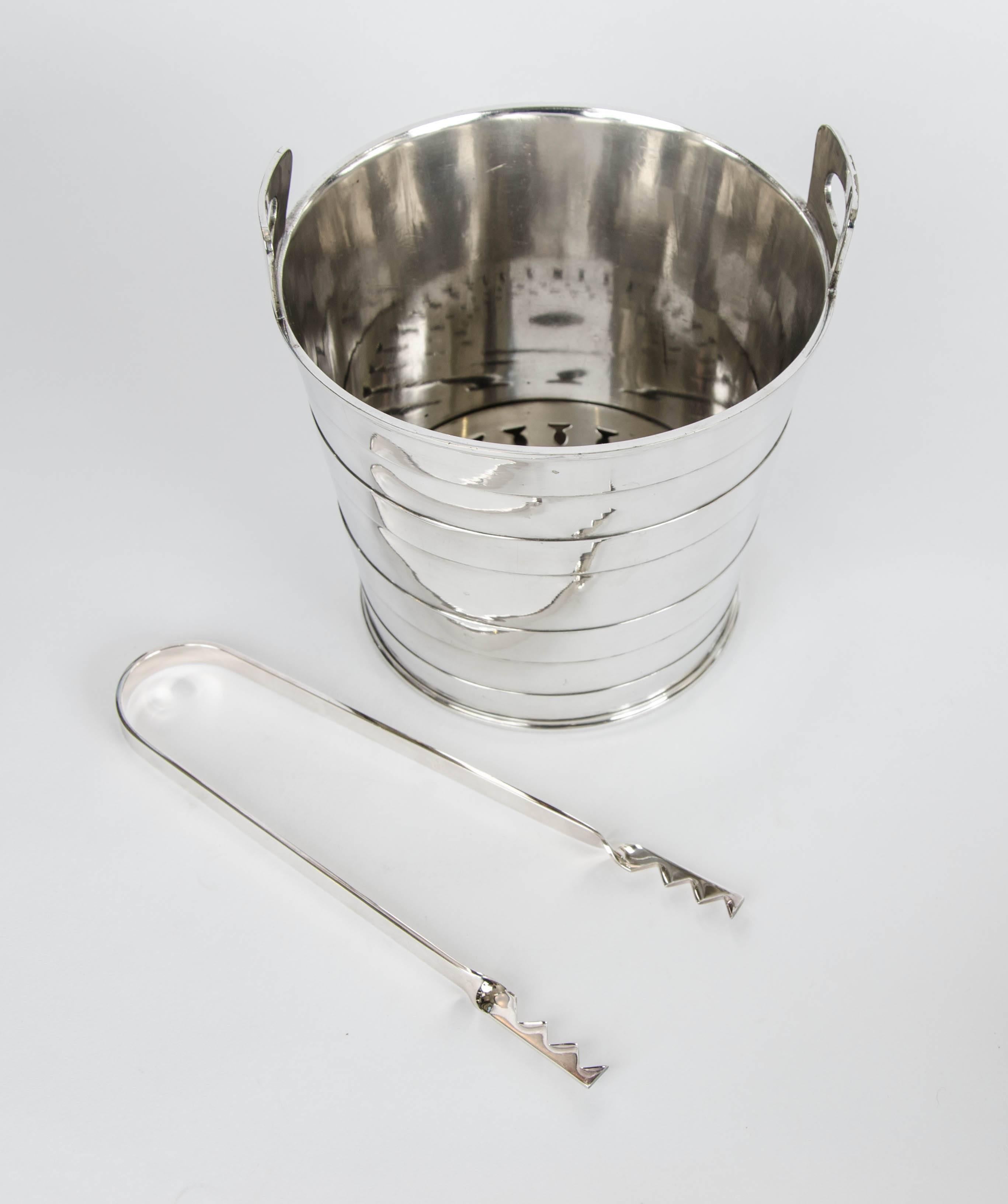 A silver plate ice bucket and tongs. Deco inspired, 1930

Mappin and Webb.