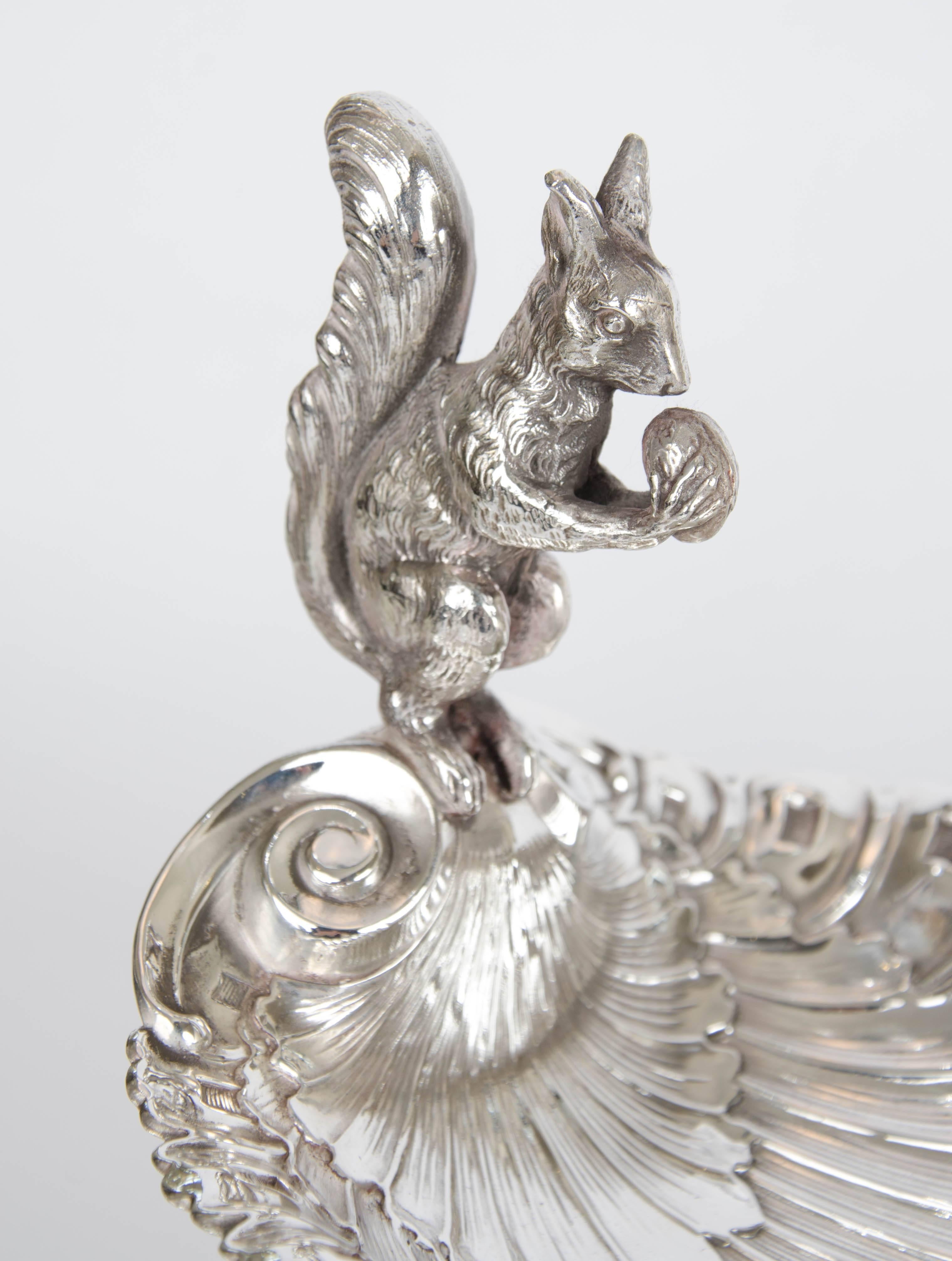 Ornate silver plate serving dish with a squirrel figurine, circa 1890. A fun way to serve assorted nuts or tidbits to your guests at a cocktail party.

Please contact us for shipping prices.
