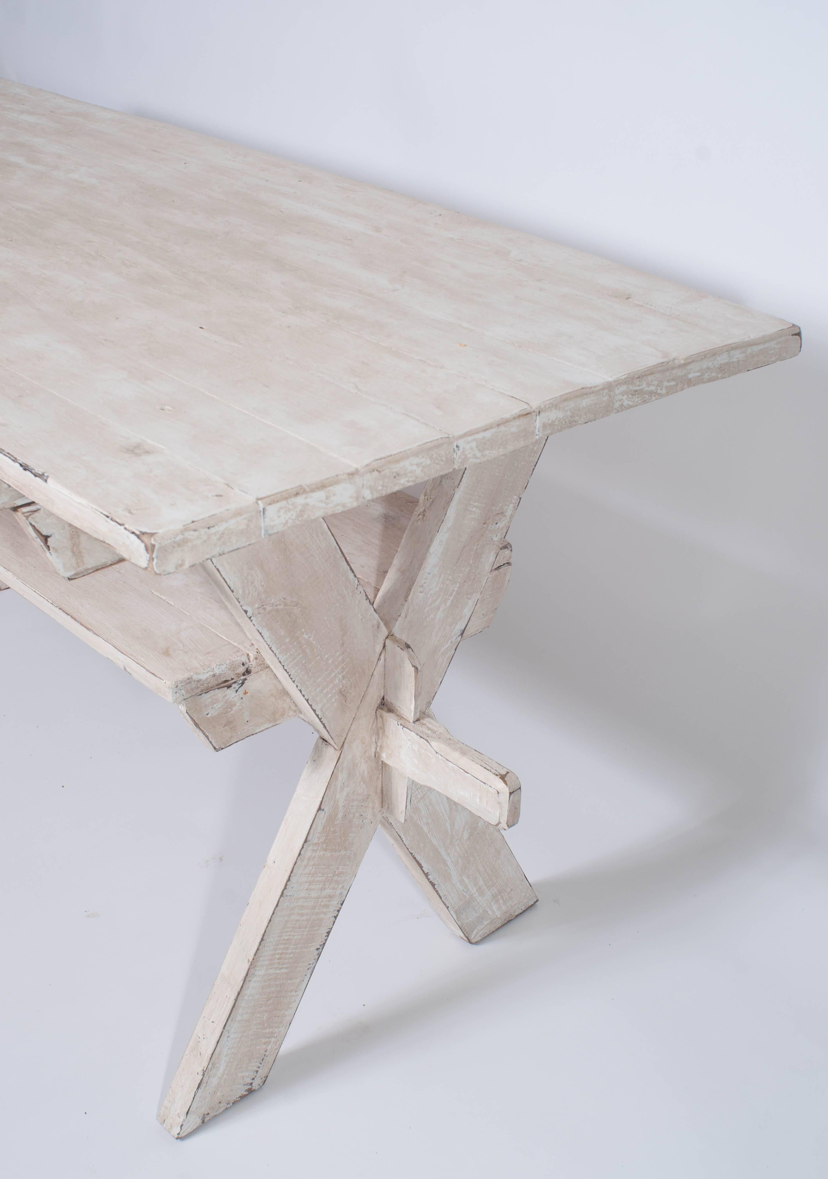 An interesting rustic sawbucks style stretcher base trestle table with a 1.25