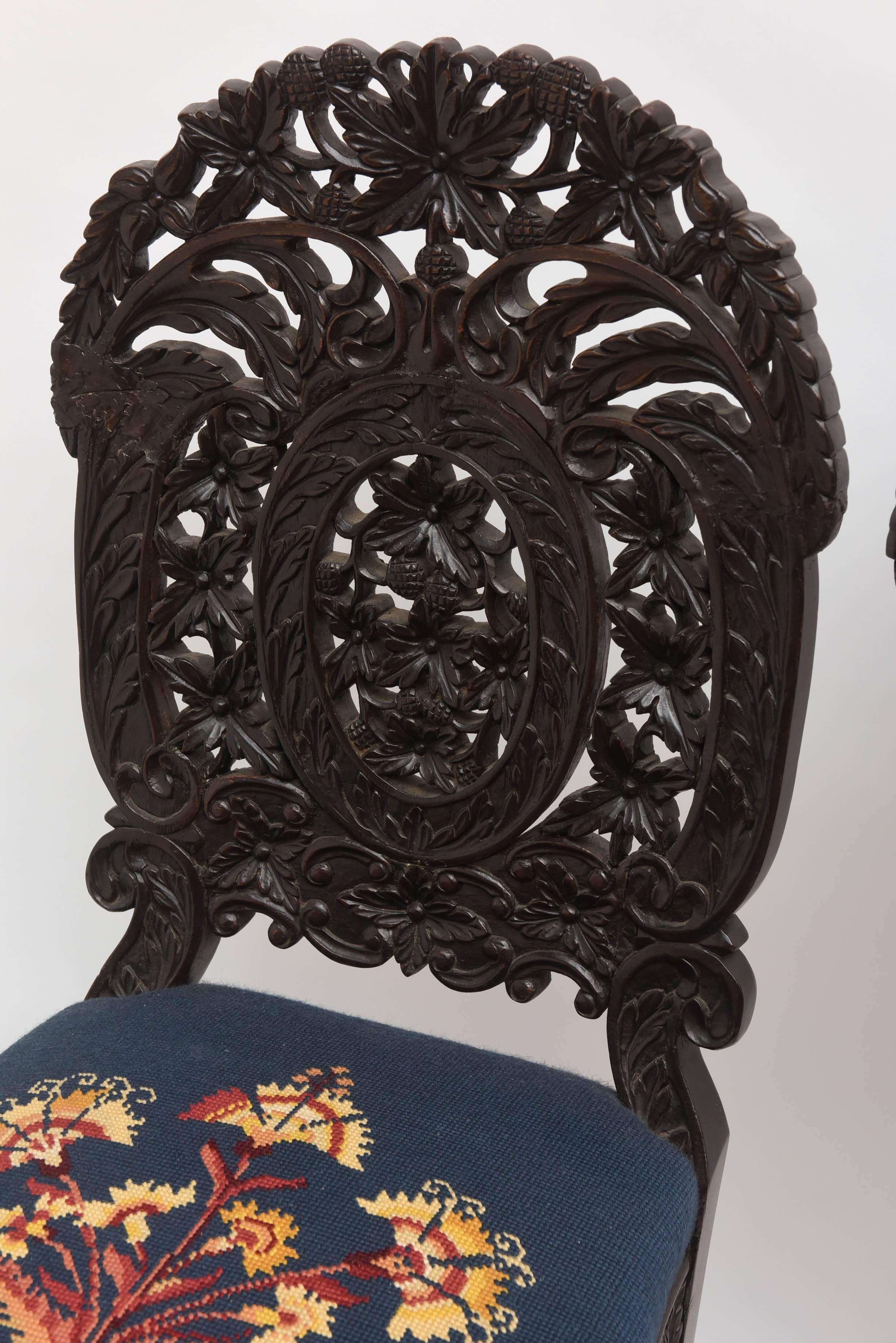 An exceptional and rare set of six with superior and intricate leaf and berry carving. Unusual form and style.