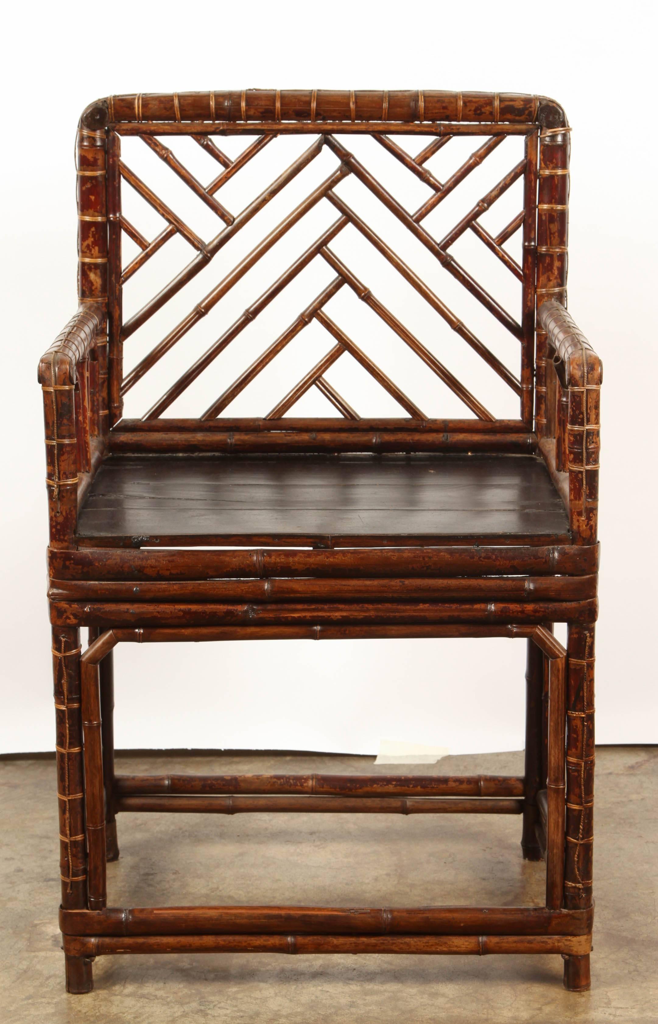 19th Century Chinese bamboo chair with a black seat.