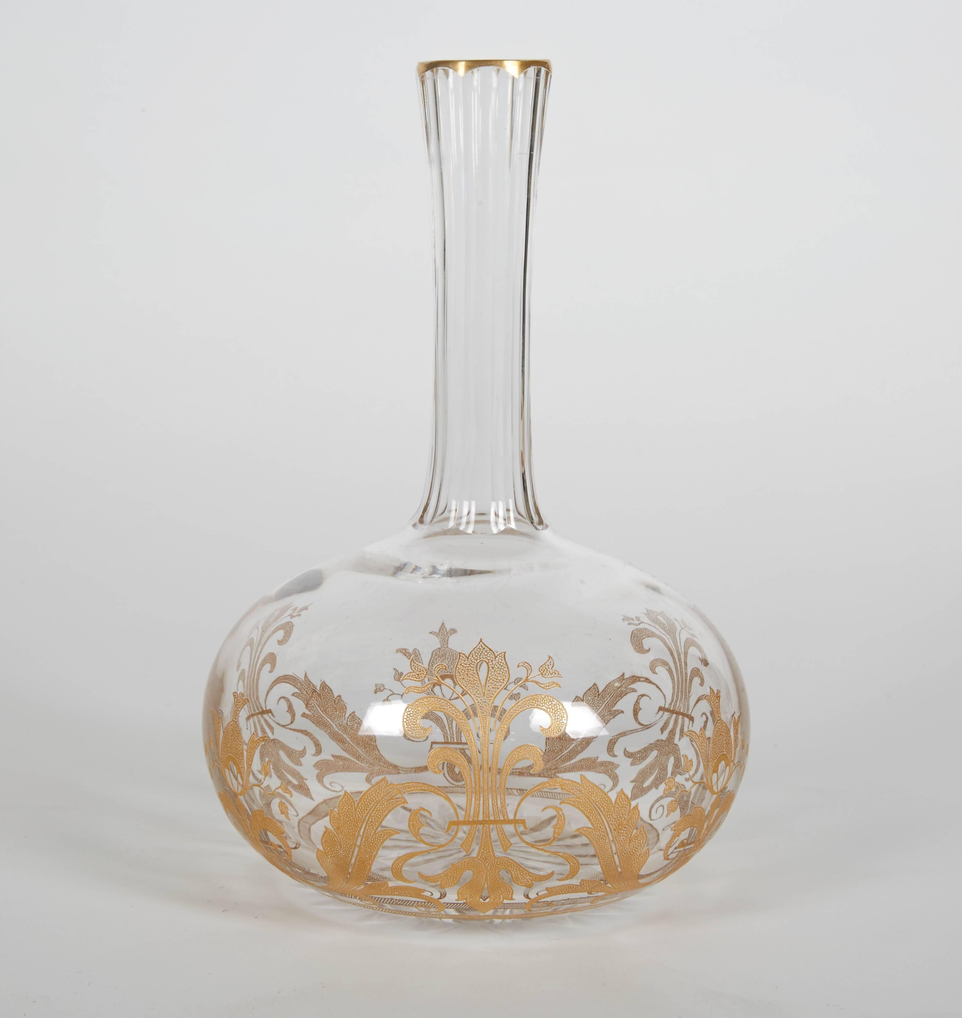 Pair of clear and tall Baccarat carafes. Gilded gold is elegantly displayed on the glass. The carafes are perfect for entertaining during cocktails, dinner or dessert. Baccarat crystal is a manufacturer of fine and luxury crystal glassware located