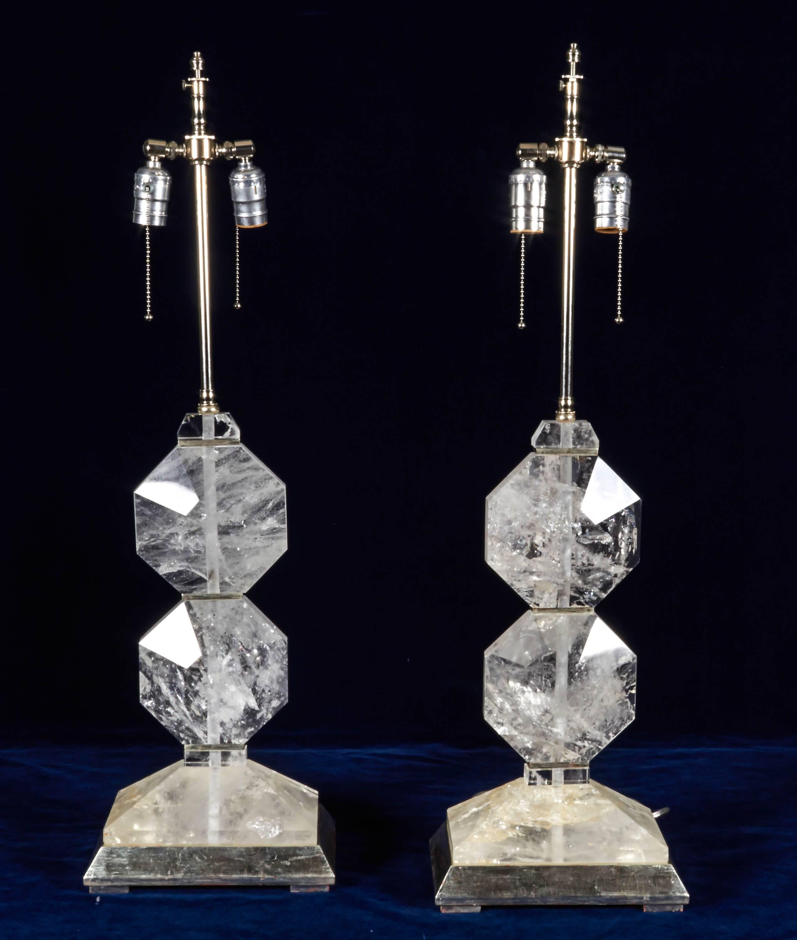 A fine pair of French Art Deco style, hand diamond cut and faceted rock crystal lamps, mounted on rectangular shaped platinum bases. In the style of Maison Jansen.

The height without electrical fitting is 18.5
