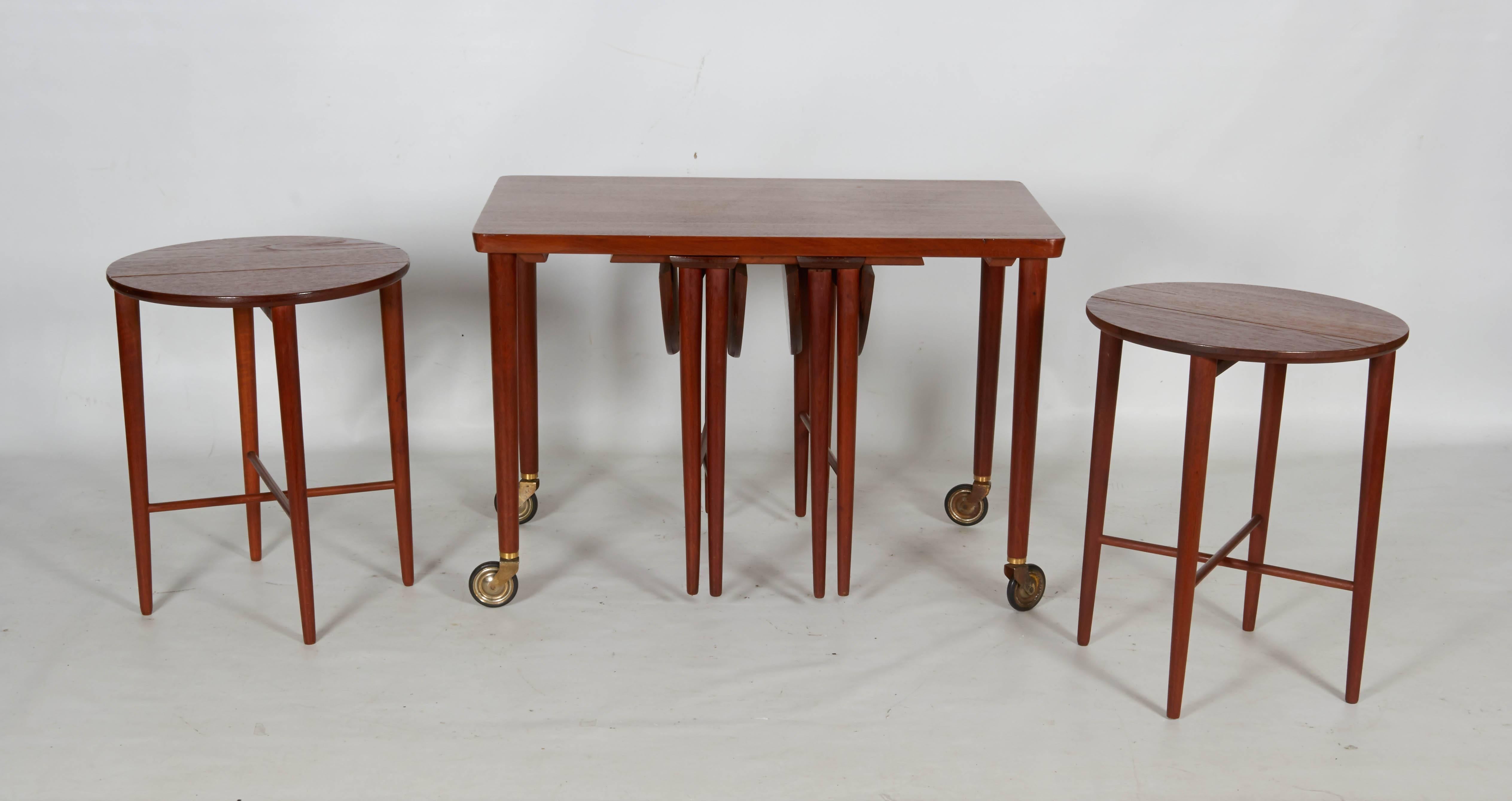 Nicely done set of nesting tables suspended from a rolling cart. The set is a very versatile serving cart, and each table is quite charming. Each table measures 14.75