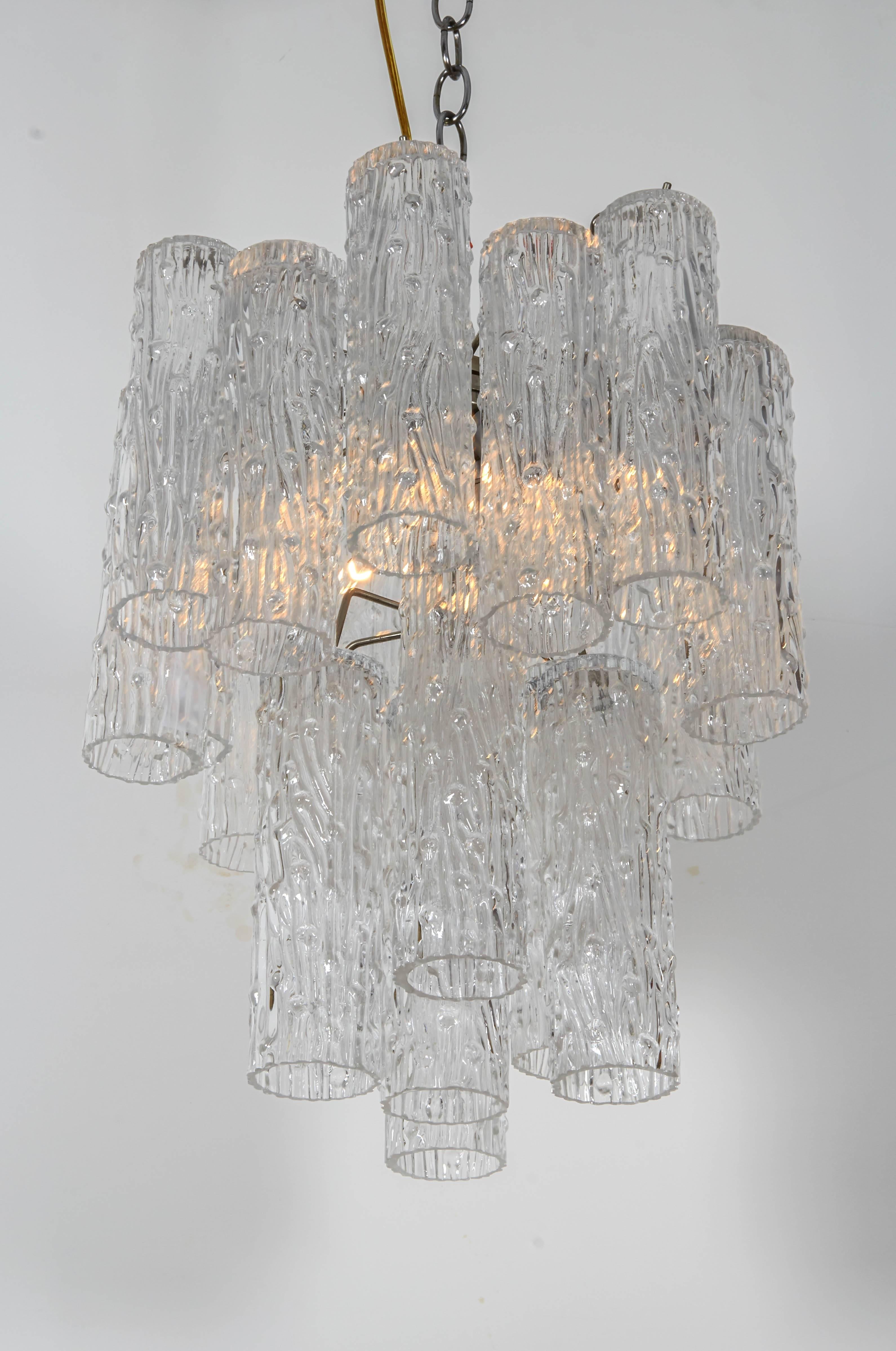 Lovely multi-tiered chandelier with heavily textured tronchi crystals. A very pretty chandelier in a versatile scale. Please contact for location.