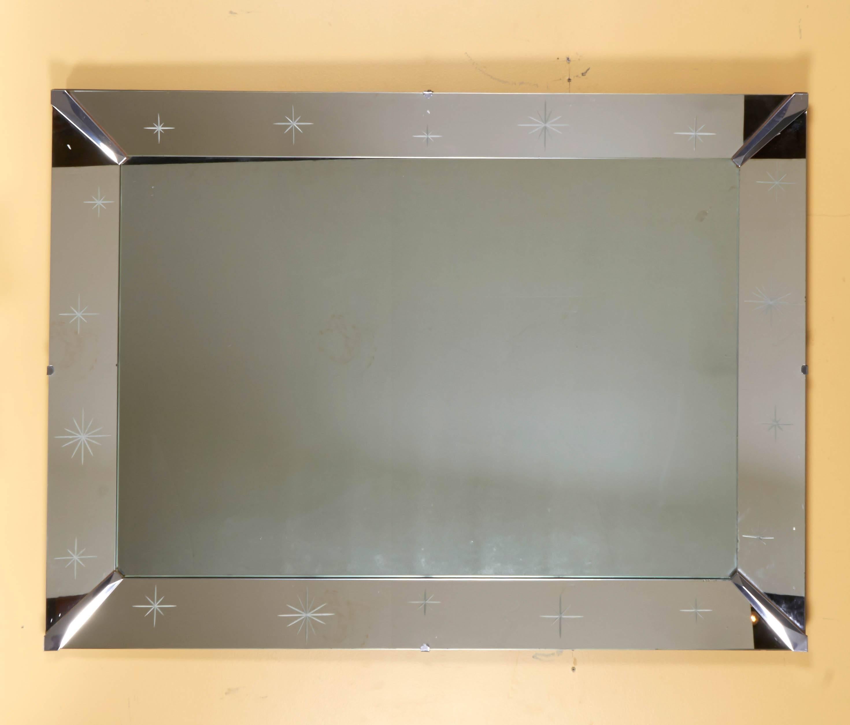 Wonderful mirror with mirrored frame and chrome joints. Accented with charming etched 
