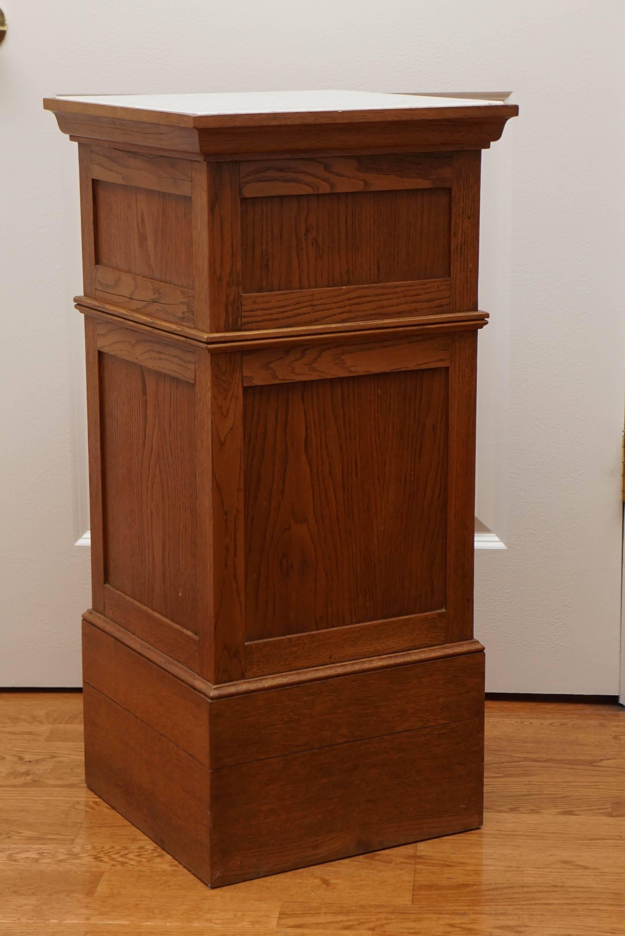 versatile, solid oak, vintage, pedestal stand with handsome, paneled sides and a marble top inset.