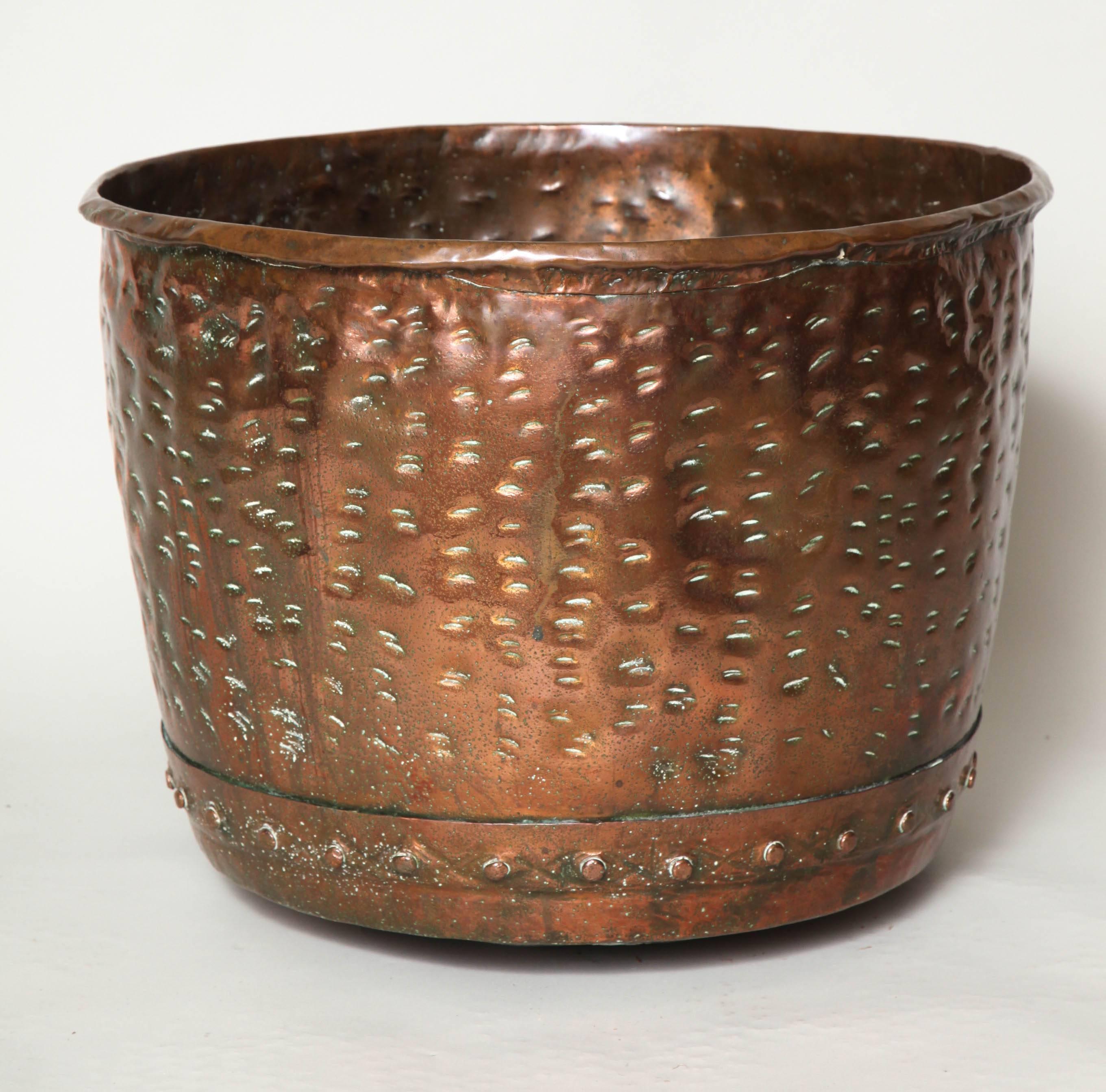 Unusual English mid-19th century copper log bucket with rolled edge, hand riveted seams and unusual hand hammered dimpled surface having a pleasing warm glowing surface.

Firewood holder, log bin, planter.