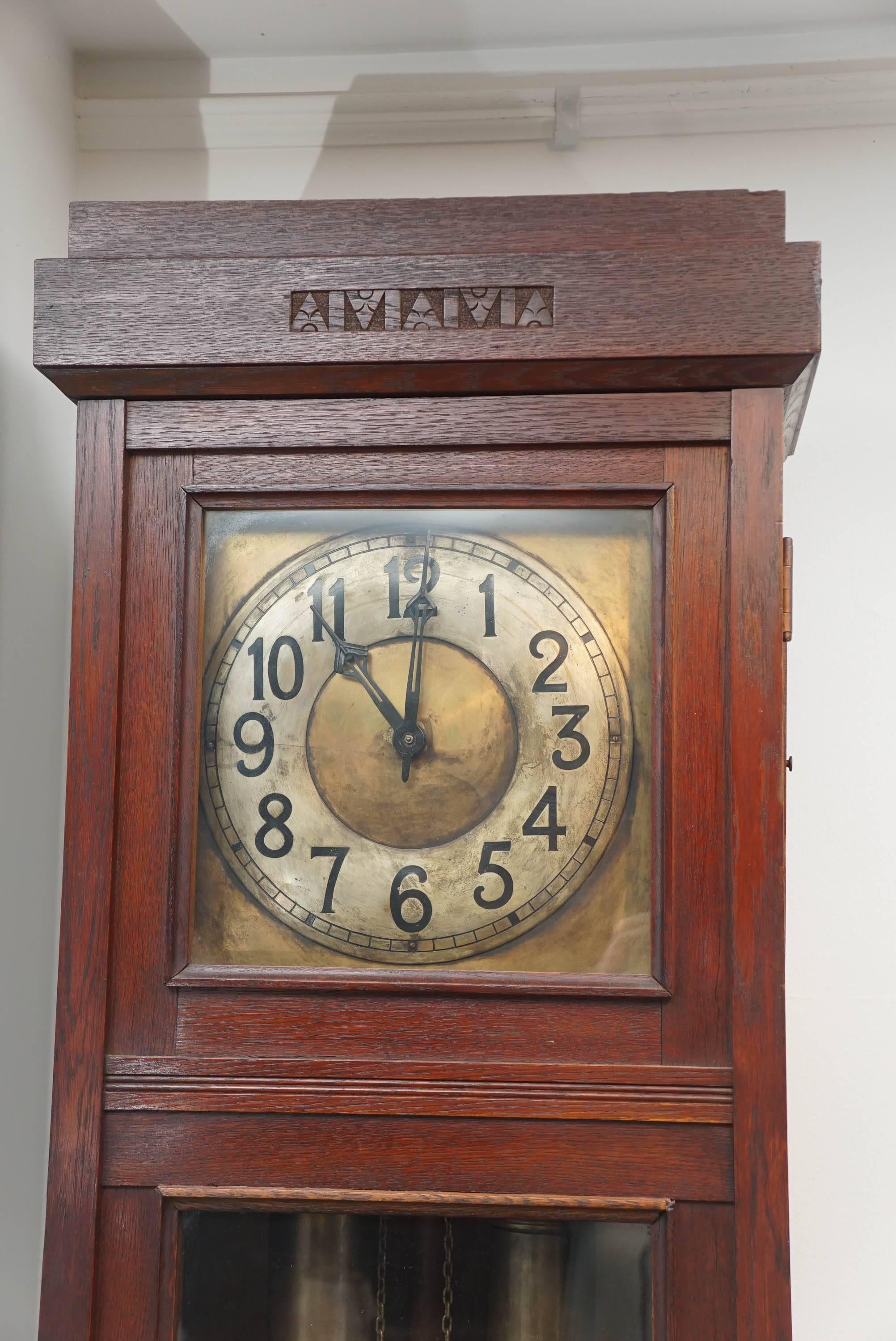 Elegant design motifs adorn this stately and simple tall clock. The manufacturer is Lenzkirch, and the face, pendulum and weights are intact. The clock has a key but is not in working order. It is structurally sound and makes an important statement