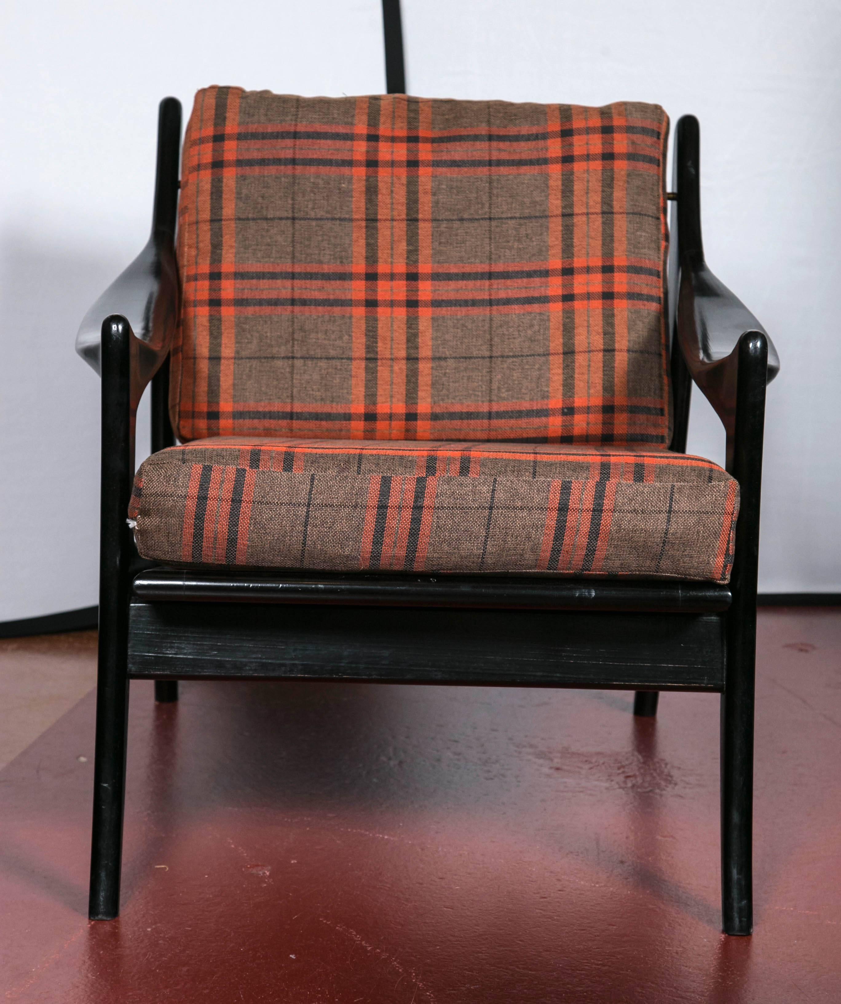 Pair of Danish ebonized flannel upholstered modern armchairs. This sleek and stylish pair of wide and comfortable armchairs, are designed in the Mid-Century Modern style. Having flair and style the wide frames are all wooden and hand made supporting