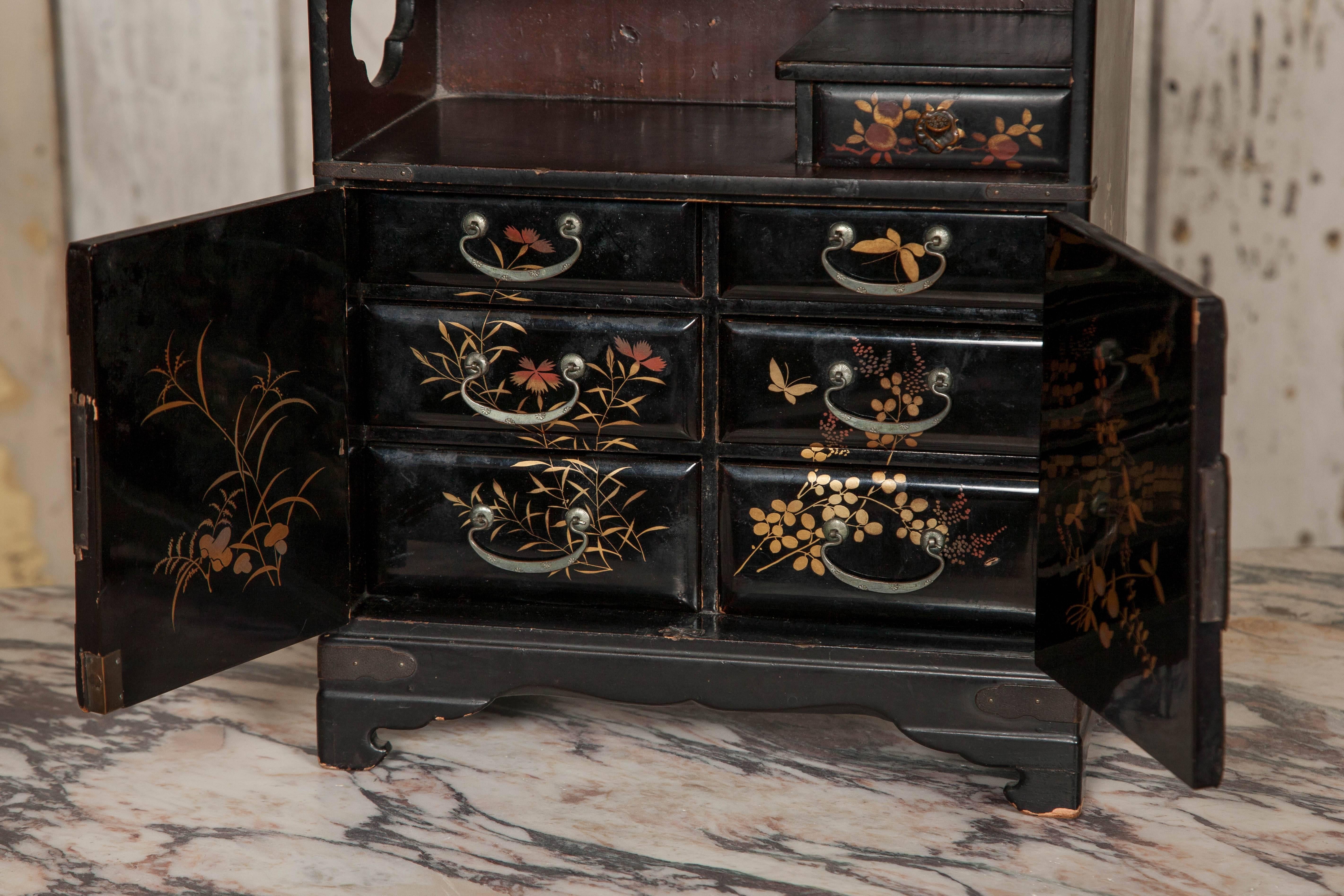 An original antique Chinoiserie miniature cabinet featuring hand-painted gilt designs on lacquer.

 