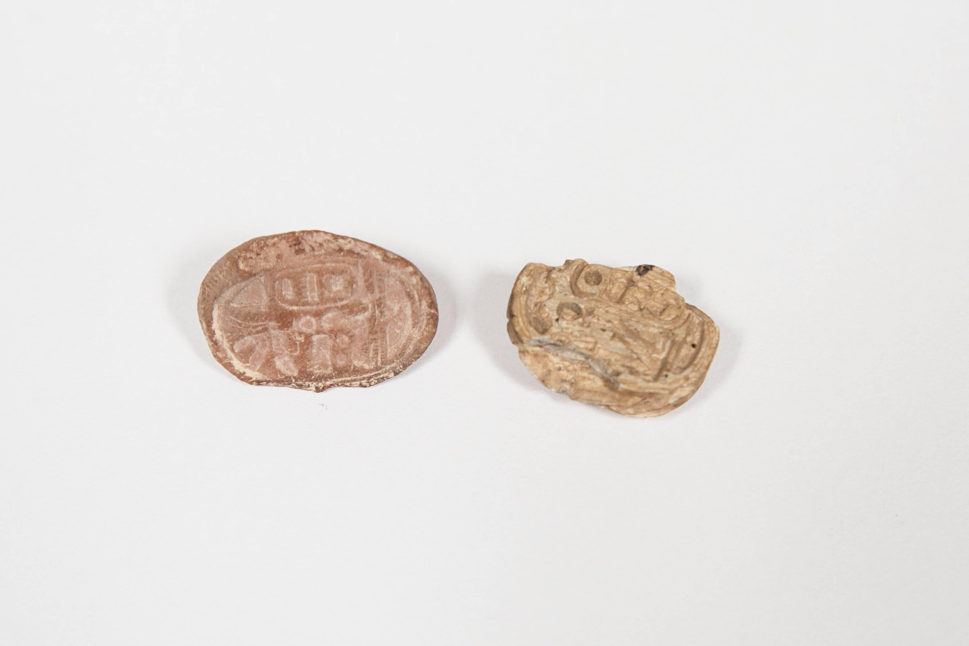 A collection of ancient Egyptian burial scarabs. These miniature carved scarabs were placed in the tombs as burial offerings.
