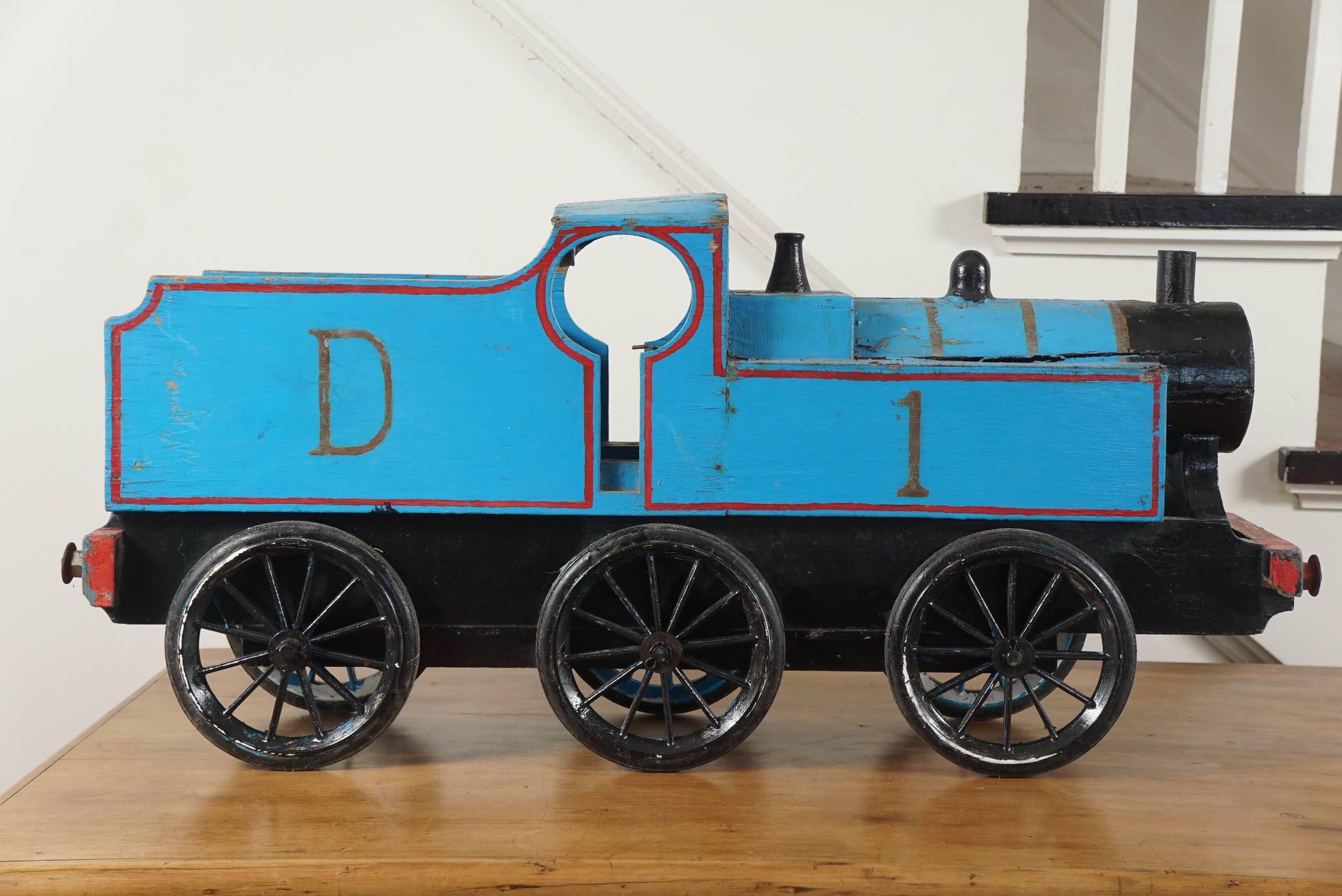 This is part of a much larger collection of children's toys at painted porch. We particularly love toy trains and this blue train makes quite a statement for a country accessory. Done in blue and red with six original wheels.