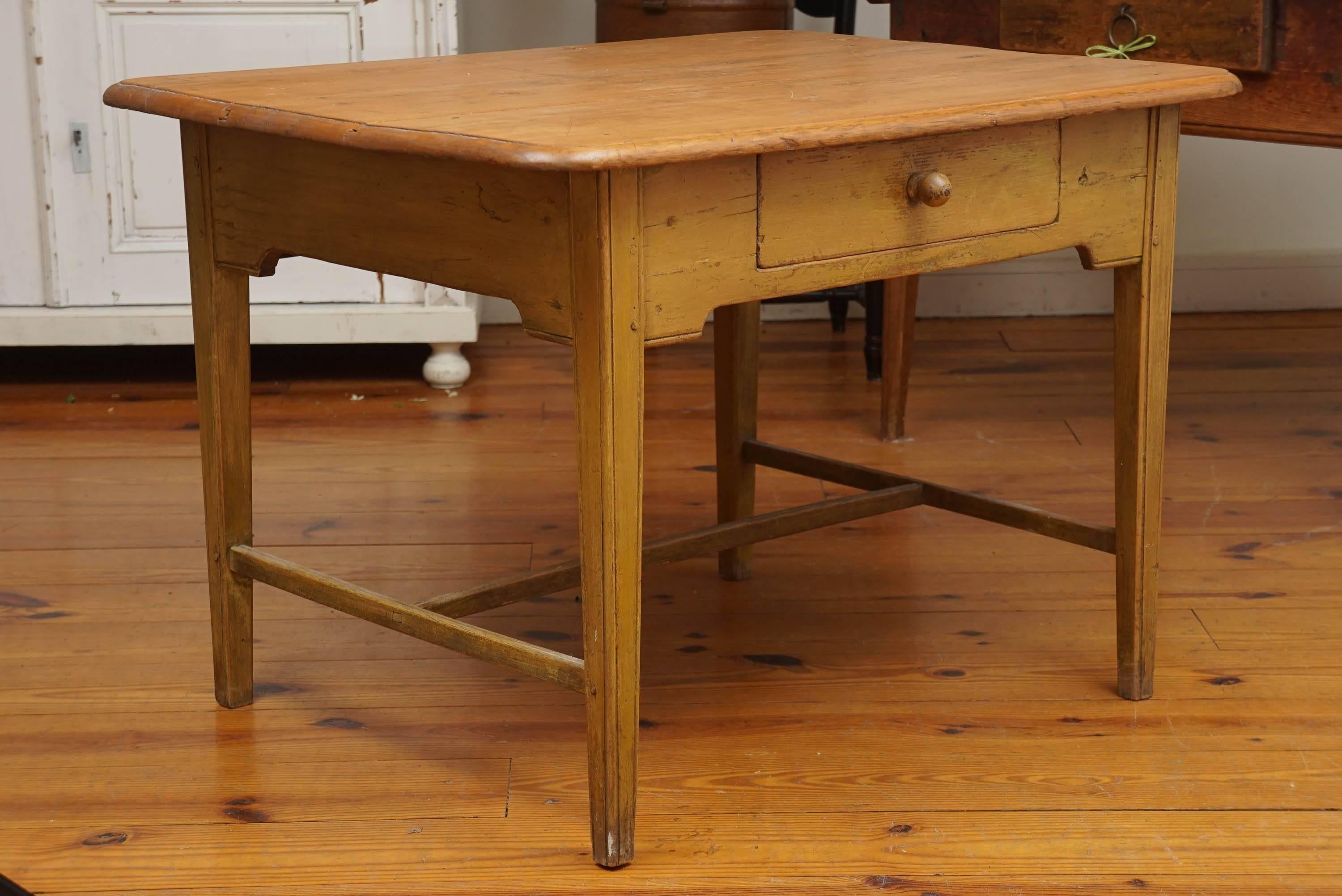 This Canadian farm table from, circa 1870 has a scrubbed pine top of three wide boards and original yellow painted base. The base has one good size drawer, a 