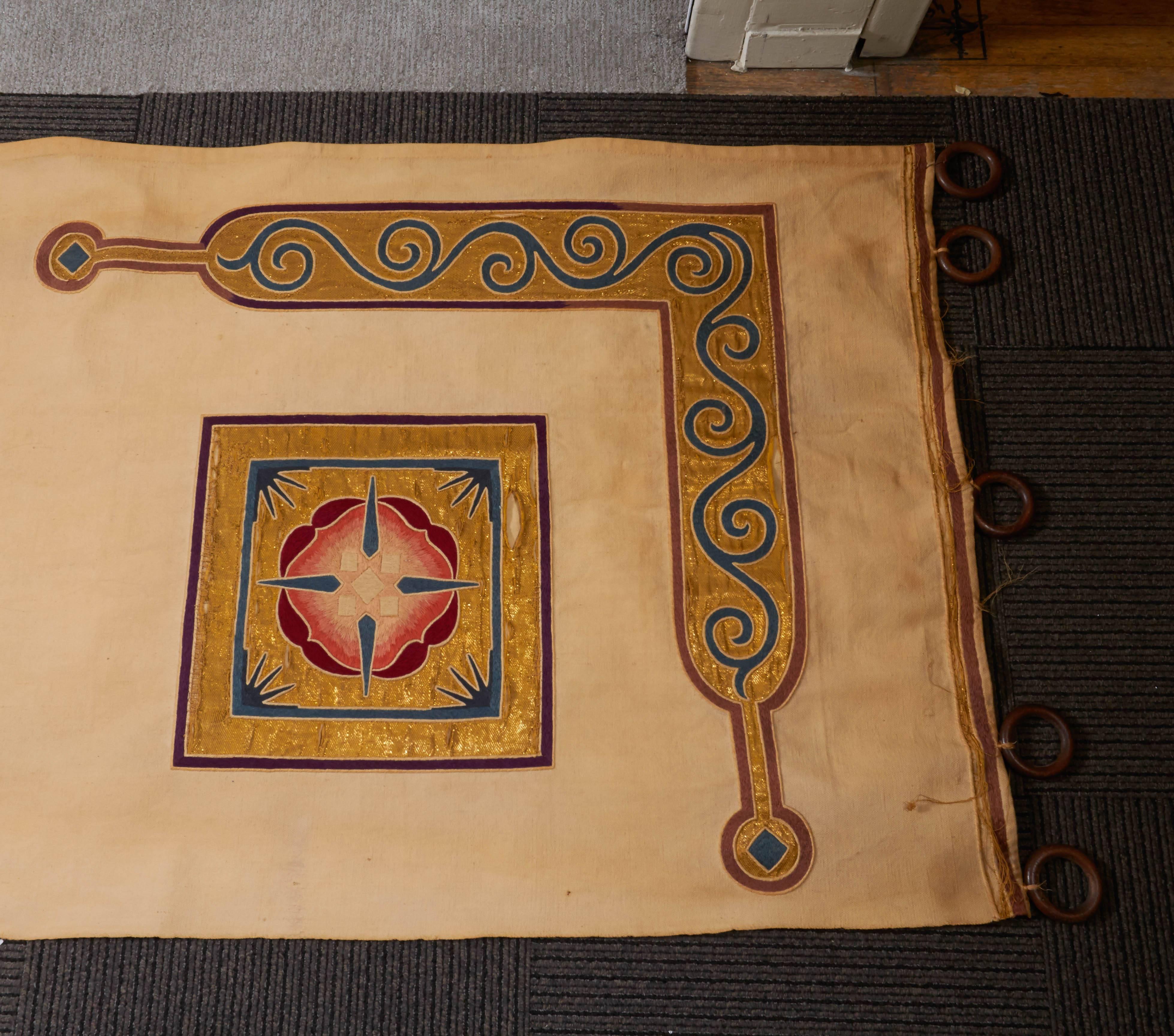 A wonderfully long pair of reversible late 19th-turn of the 20th century Arts & Crafts archway portiere. The panels are not only hand embroidered on the front and the back with metallic gold threads and shades of burgundy thread but also appliqued