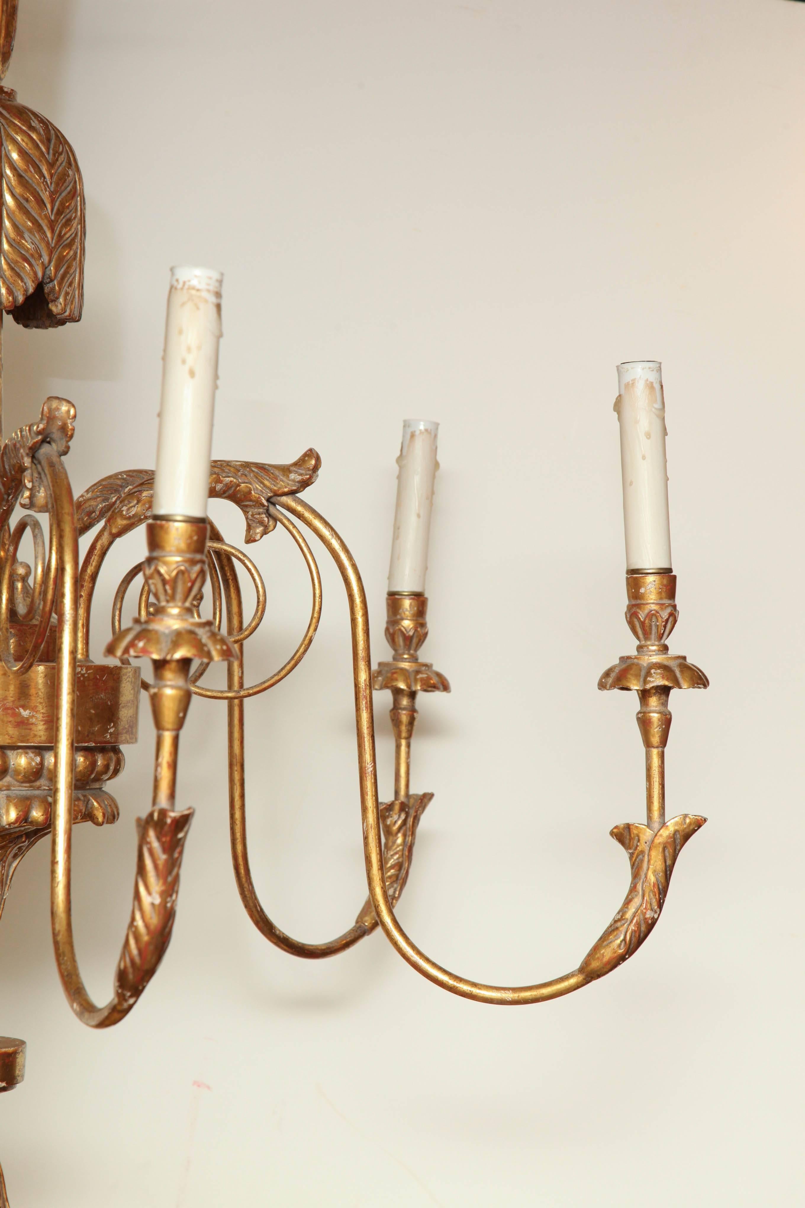 An unusual large Regency carved giltwood six-light chandelier with carved acanthus and acorn finial.