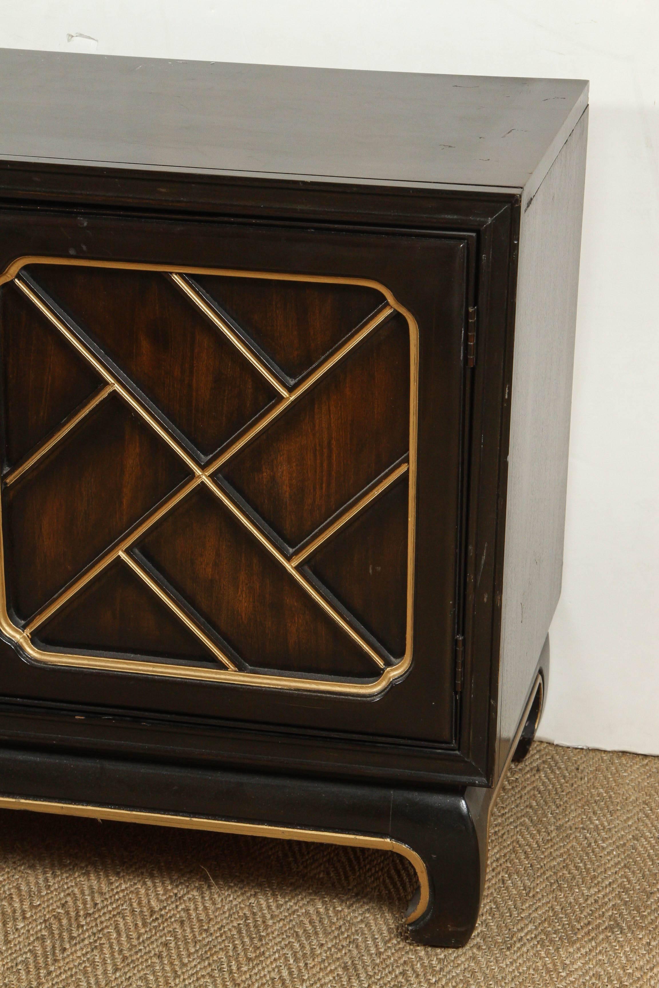 Dark chestnut Chippendales style credenza with bamboo detail on the front with gold handles on the drawers.