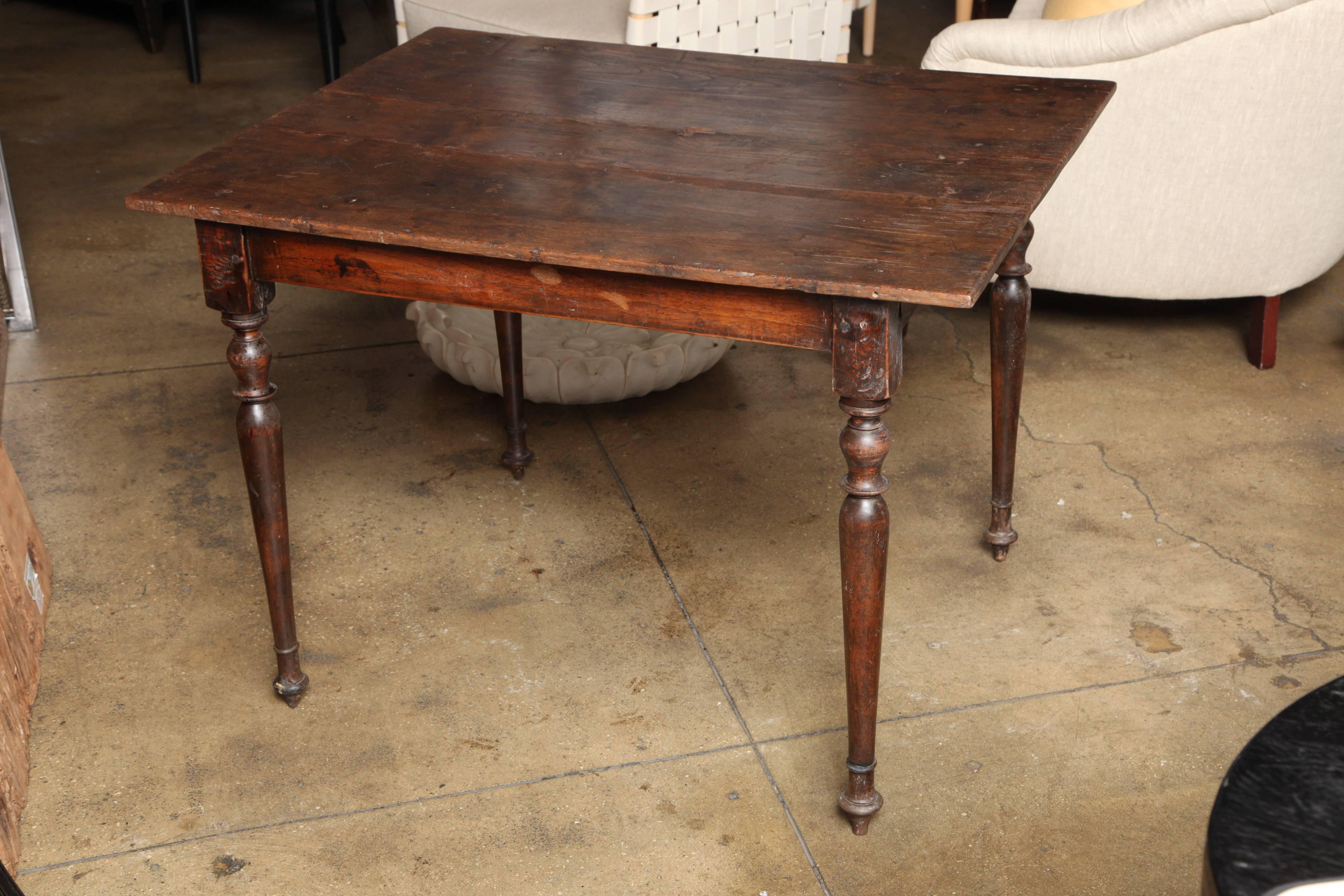A teak wood table with turned legs, from Indonesia. Circa 1920. 