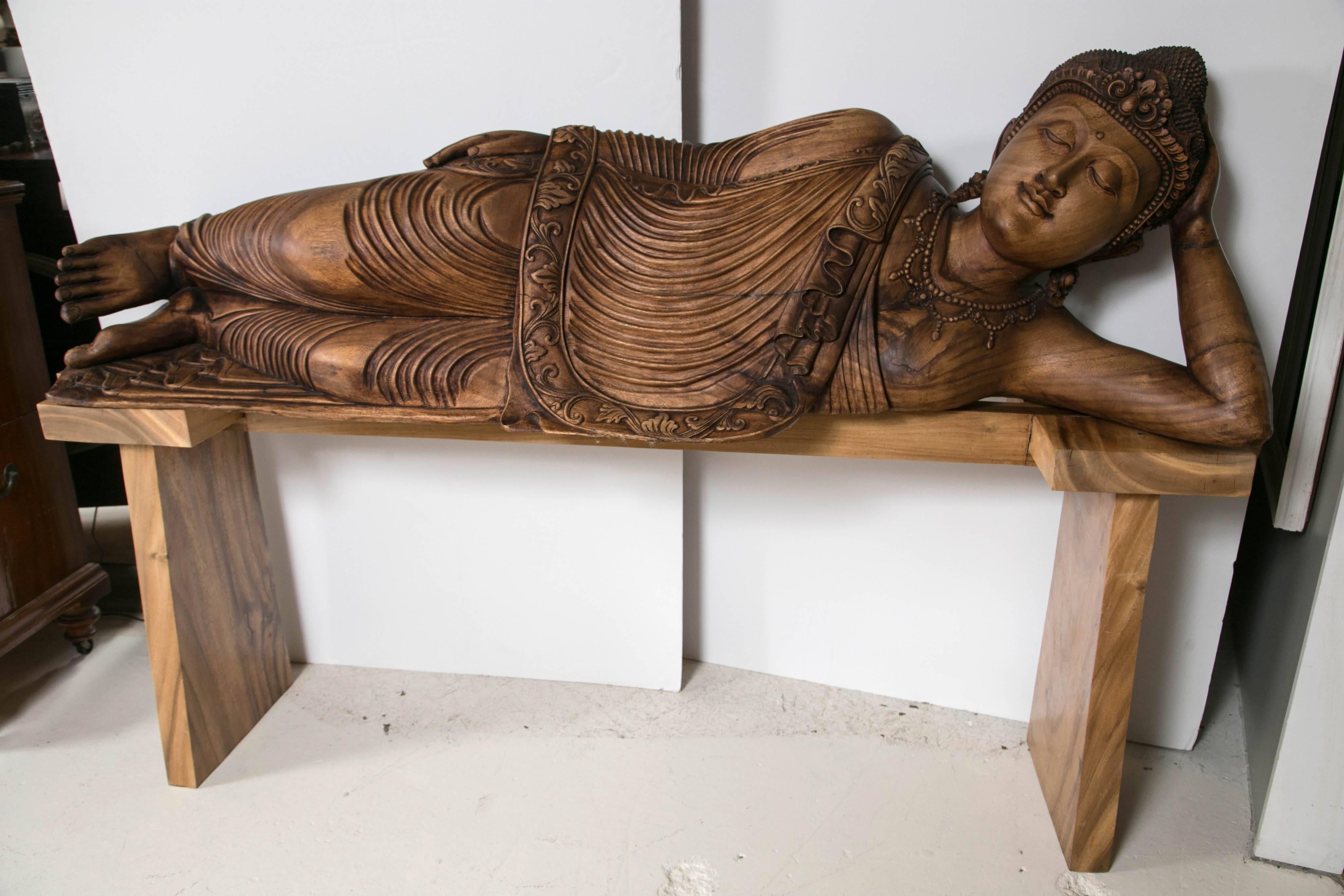 Hand Carved mahogany Buddha life size finely carved. He sits on custom hand built table of teak and mahogany. 