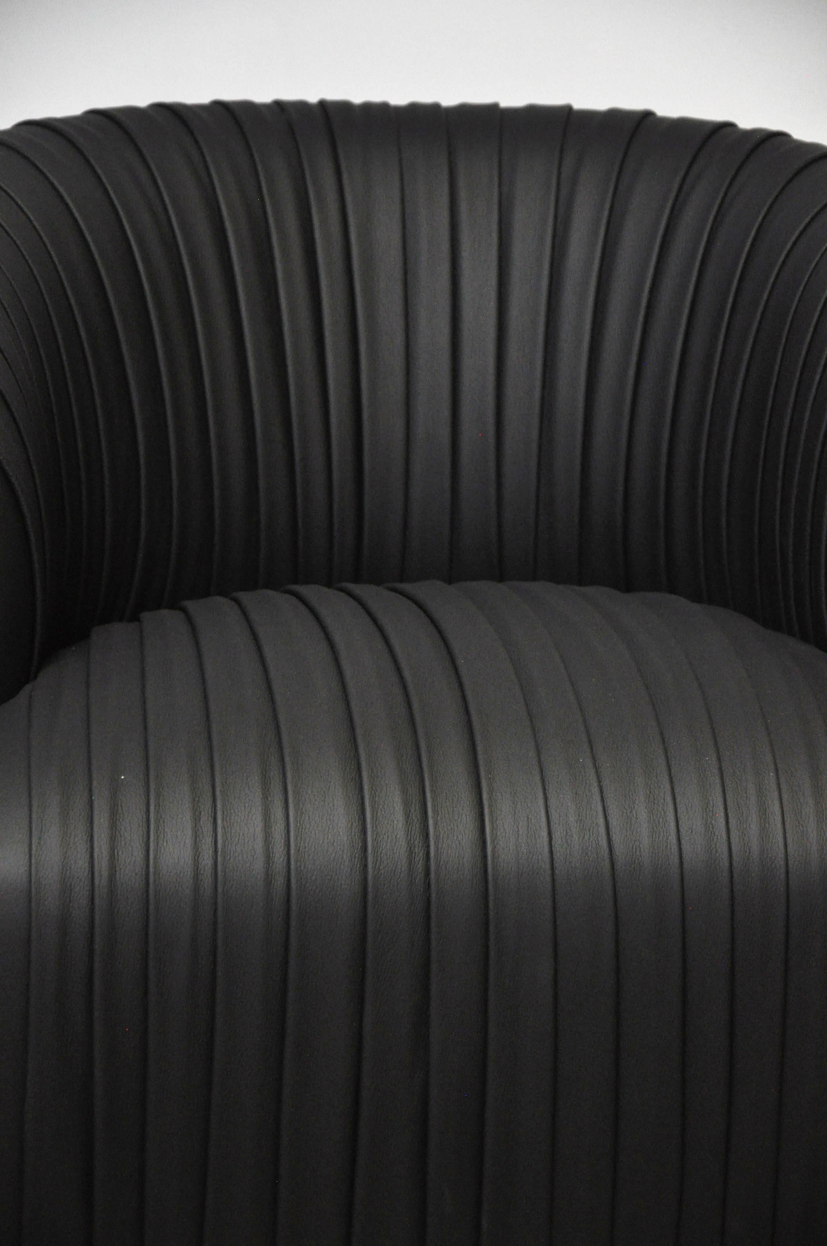Pair of swivel chairs, circa 1970s. New pleated black leather upholstery.